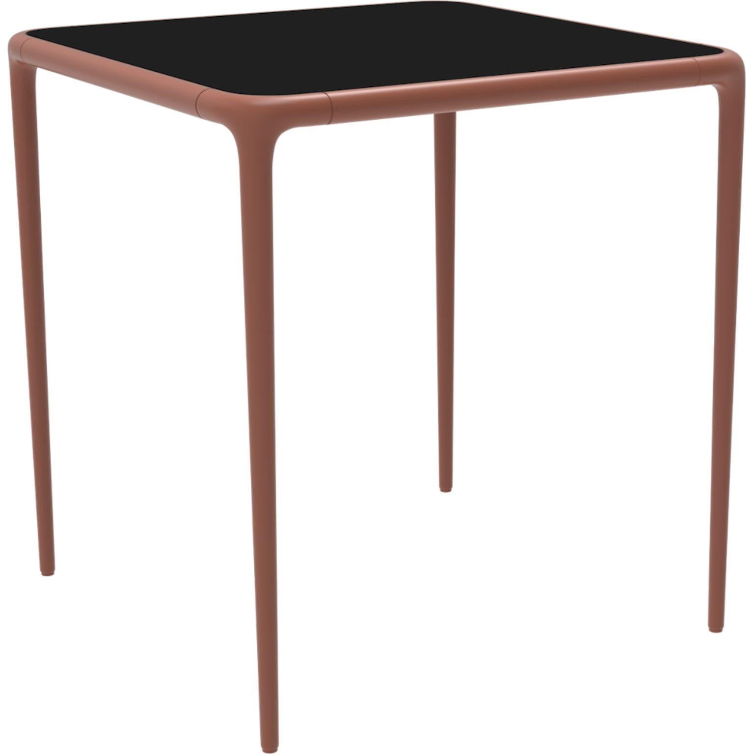 Xaloc Salmon glass top table 70 by MOWEE
Dimensions: D70 x W70 x H74 cm
Material: Aluminum, tinted tempered glass top.
Also available in different aluminum colors and finishes (HPL Black Edge or Neolith).

Xaloc synthesizes the lines of