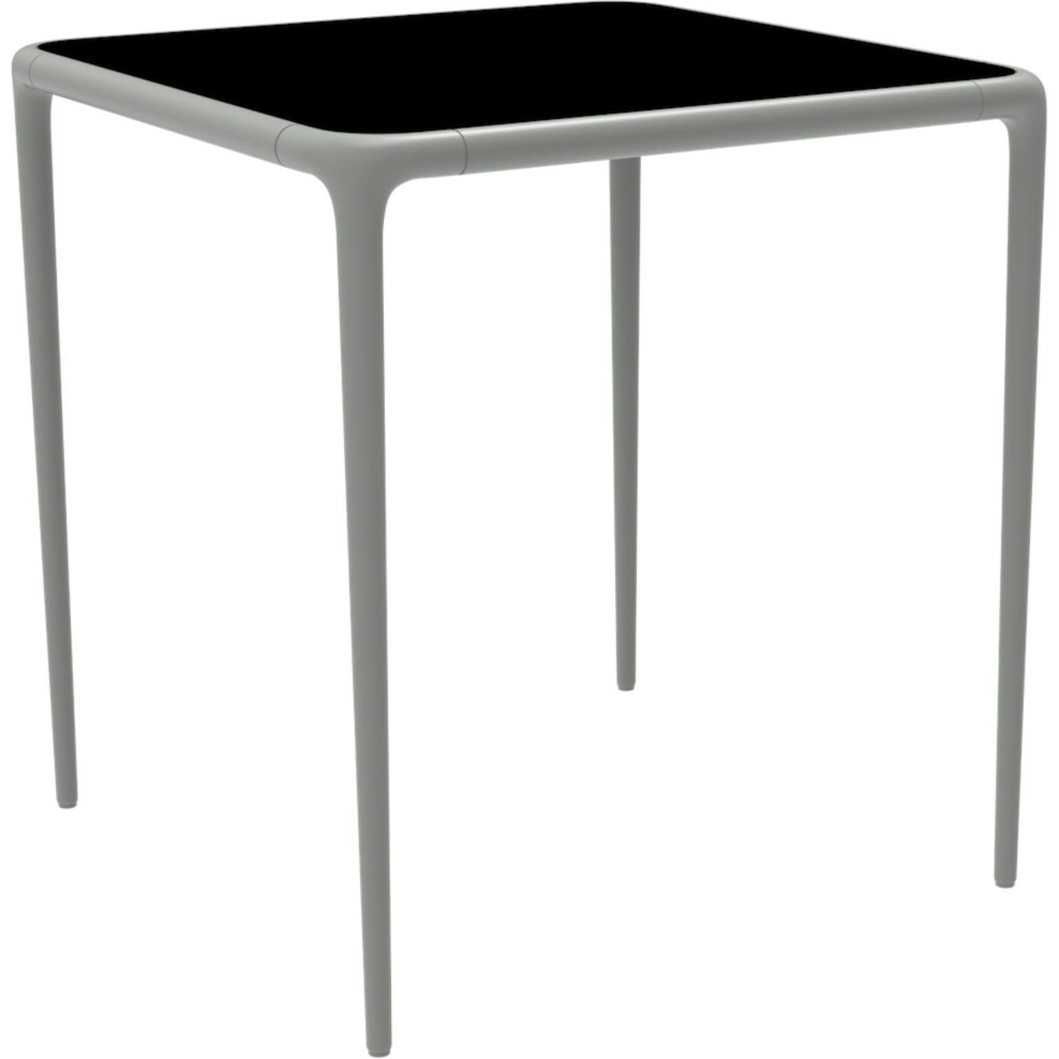 Xaloc silver glass top table 70 by Mowee.
Dimensions: D70 x W70 x H74 cm.
Material: Aluminum, tinted tempered glass top.
Also available in different aluminum colors and finishes (HPL Black Edge or Neolith).

Xaloc synthesizes the lines of