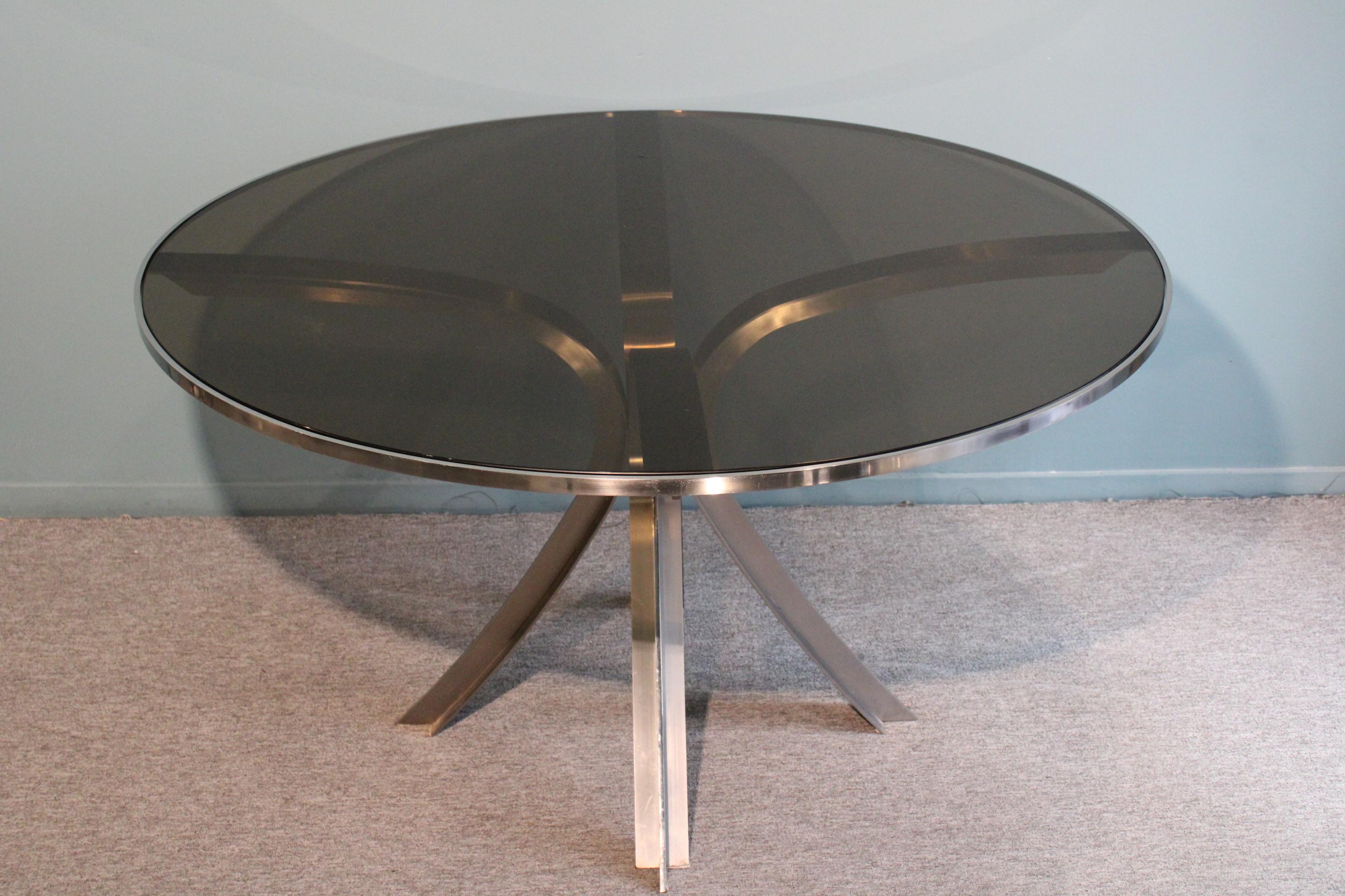 Dinning table designed by Xavier Feal.
Smoked glass top and stainless steel base.
circa 1970.