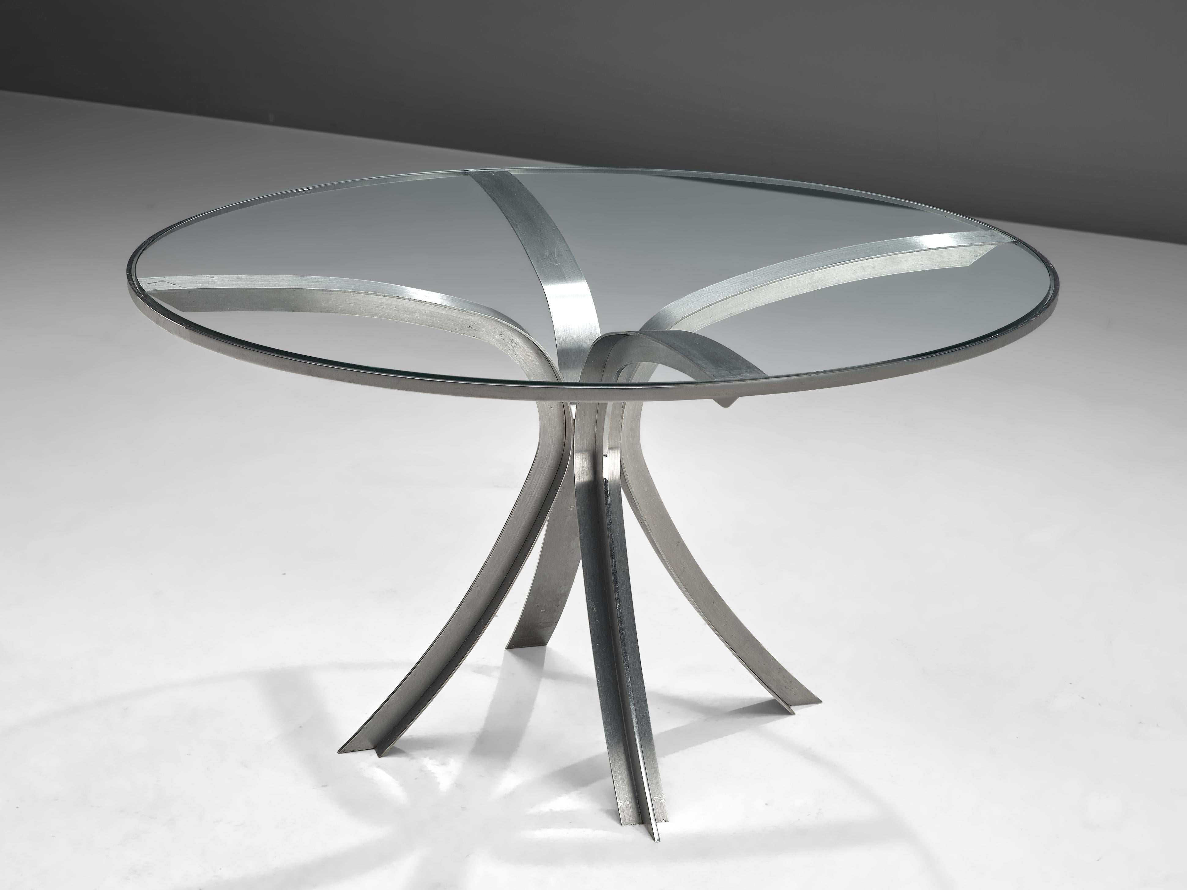 Centre table, in glass and stainless steel, France, 1970s. 

This table from the 1970s is manufactured by the Frenchman Xavier Féal. Overal, Féal's pieces are known for their excellent artisanship and durable material. Although this dining table
