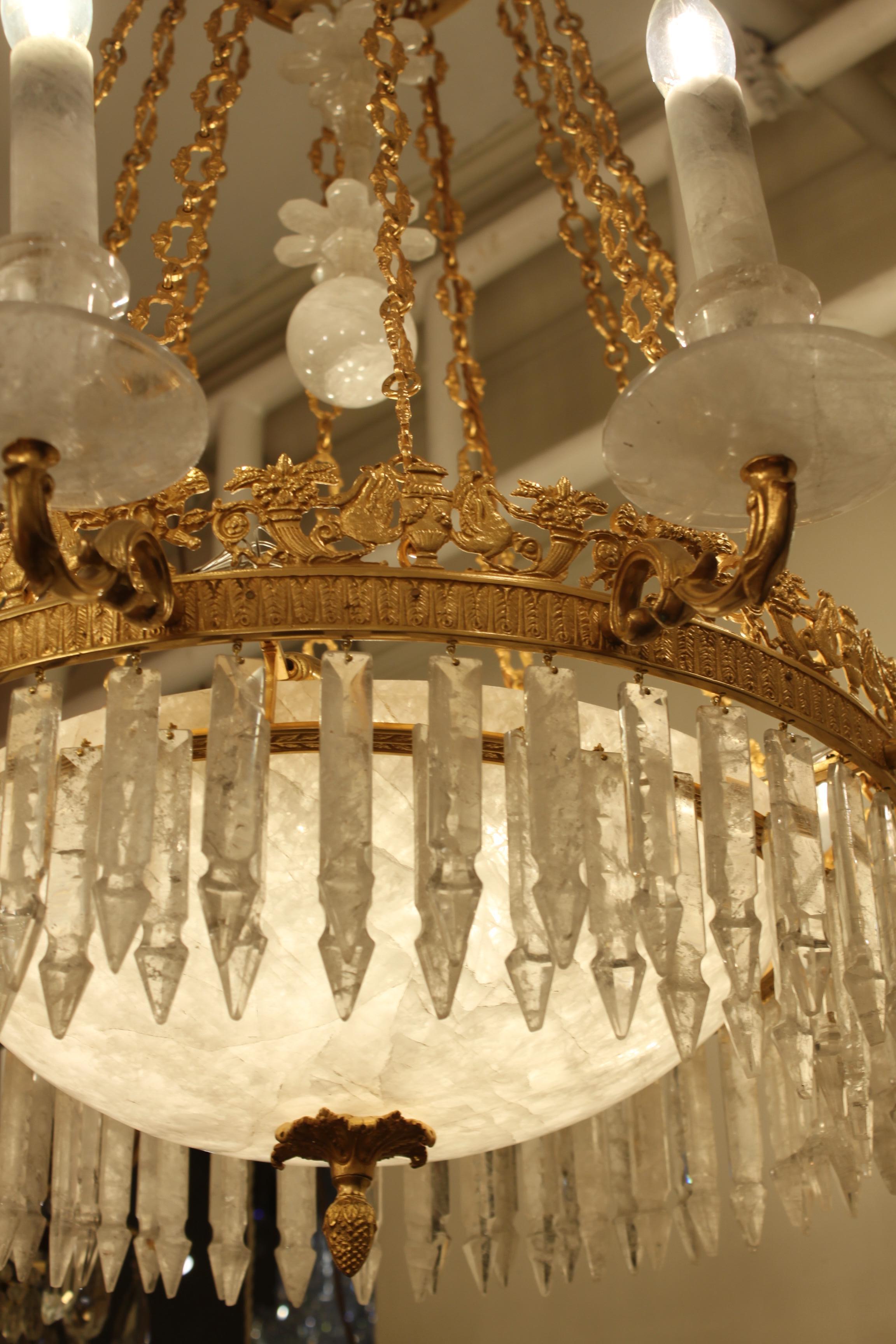 19th century French Empire rock crystal chandelier with exceptional rock crystal bottom dish. Equipped with sixteen lights and double round of icicle pieces.
