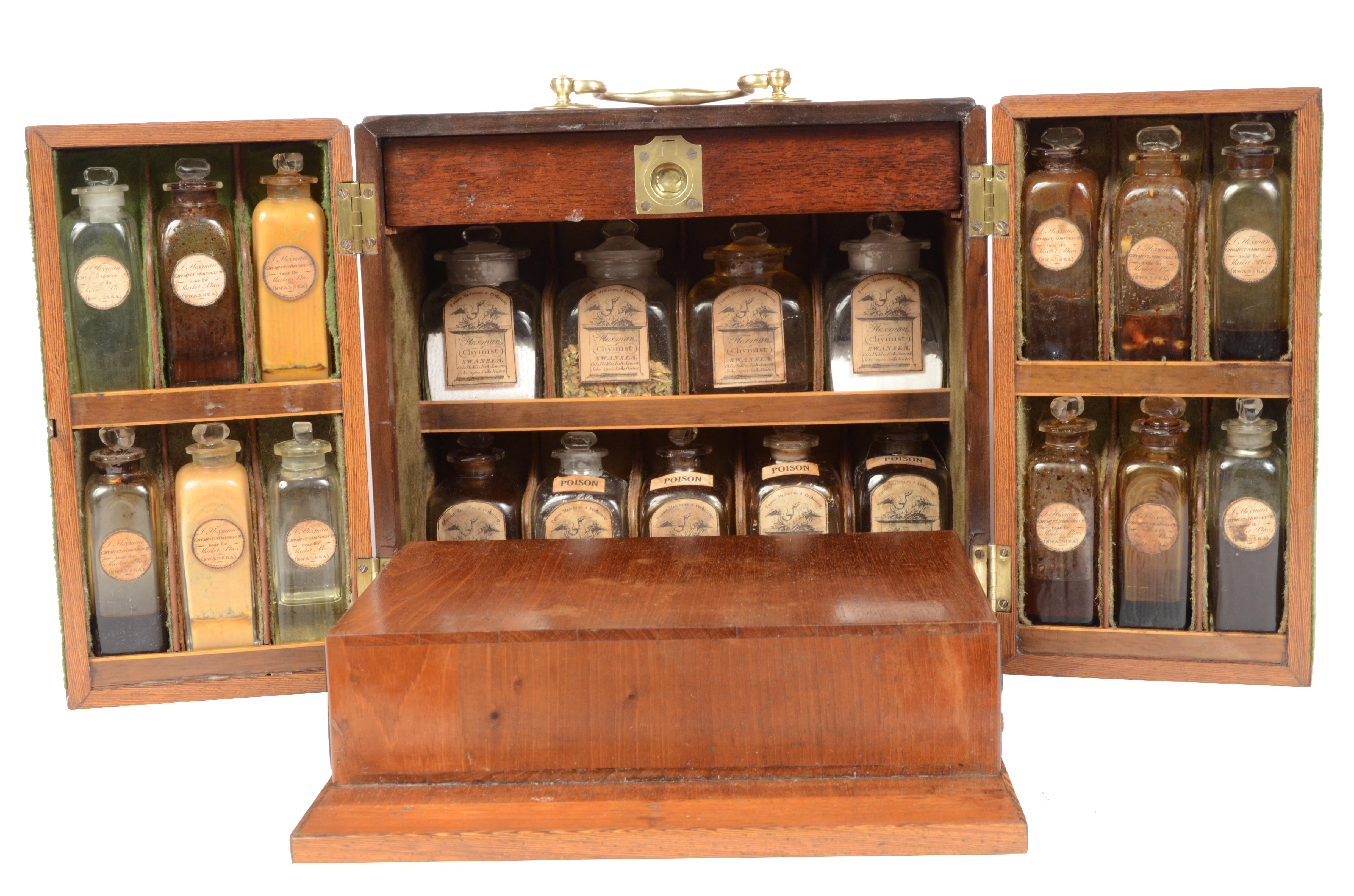 English apothecary cabinet dated to the first half of the nineteenth century, mahogany box, brass handle and hinges and complete with key. The cabinet with a rectangular base is formed by a central compartment with two shutters in which are housed