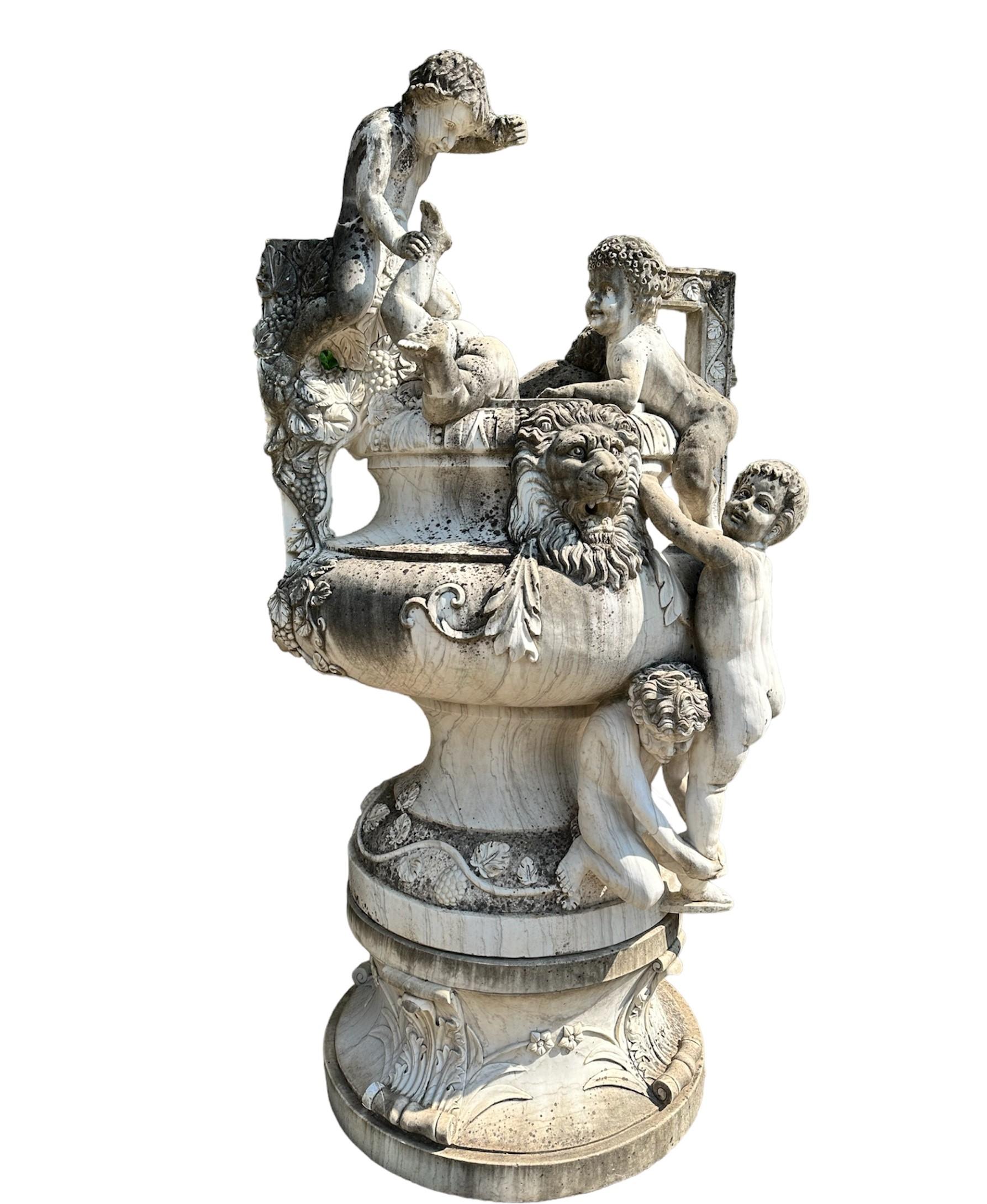 Large sculptural group made of white marble.
Inspired by the famous work by Joseph Reynés I Gurgui (Fuente de Los Ninos), the group depicts a large vase adorned with bunches of grapes with cherubs climbing up the sides until they almost 