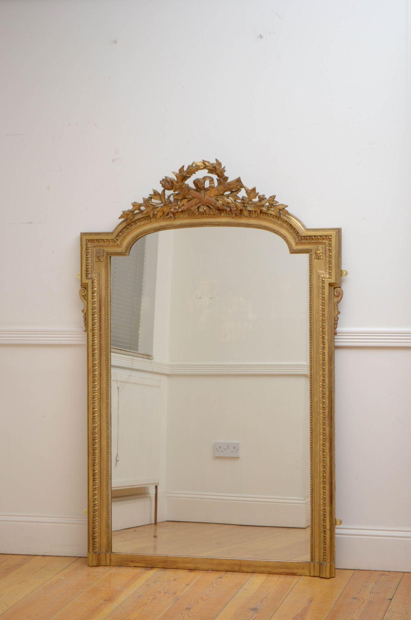 Sn5370 outstanding 19th century giltwood wall mirror, having original glass in beaded and carved giltwood frame with leafy wreath crest. This antique mirror retains its original glass, gilt and backboards, all in home ready condition.