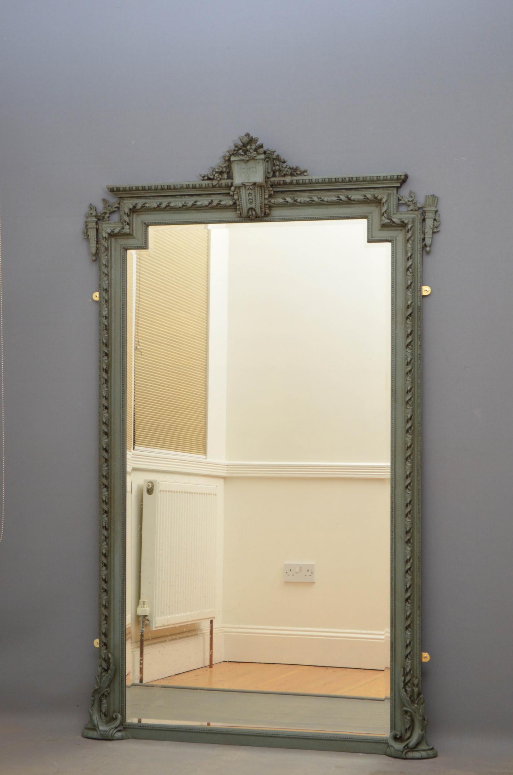 Sn4864, tall French wall mirror, having original bevelled edge glass with some foxing in beaded, oak leaf carved and moulded frame with scrolls to the base and flower carved crest to the centre. This antique mirror has been repainted and waxed, it