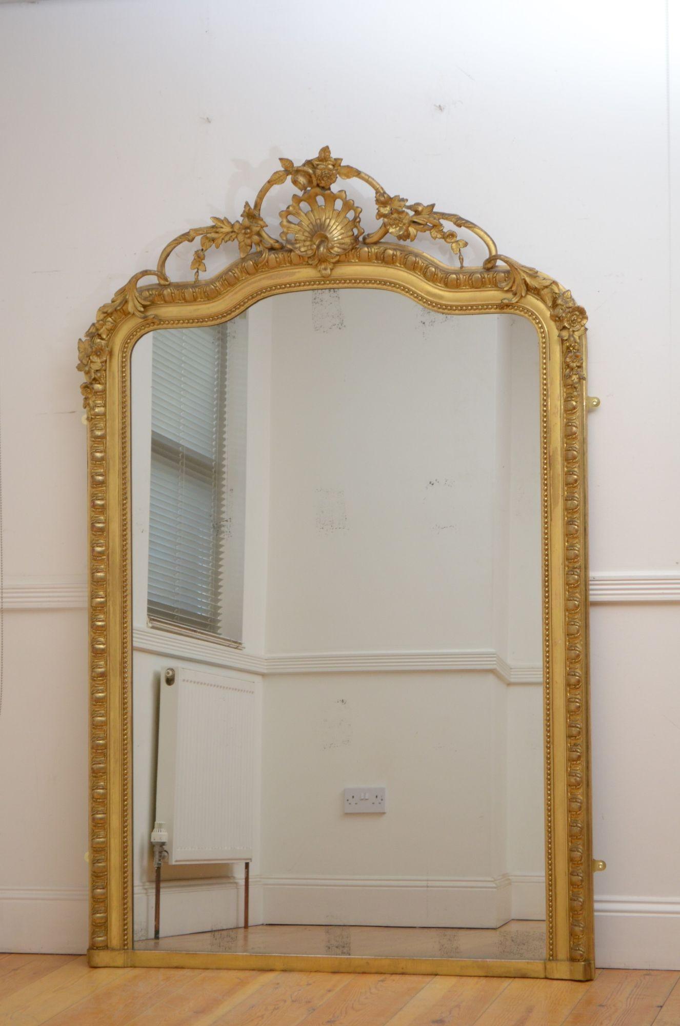 Sn5476 A superb 19th century French gilded wall mirror, having original glass with some foxing in beaded and egg and dart carved giltwood frame with foliage centre crest flanked by floral scrolls and swags. This antique mirror retains its original