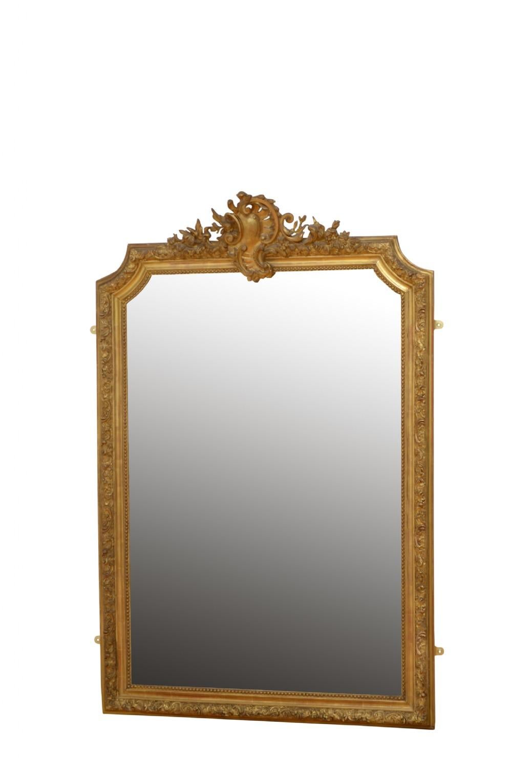 K0161 very attractive gilded mirror, having original bevelled edge glass with some foxing in beautifully carved frame with beaded edge and leafy scrolls throughout finished with a shell and floral crest to the top. This antique mirror retains its