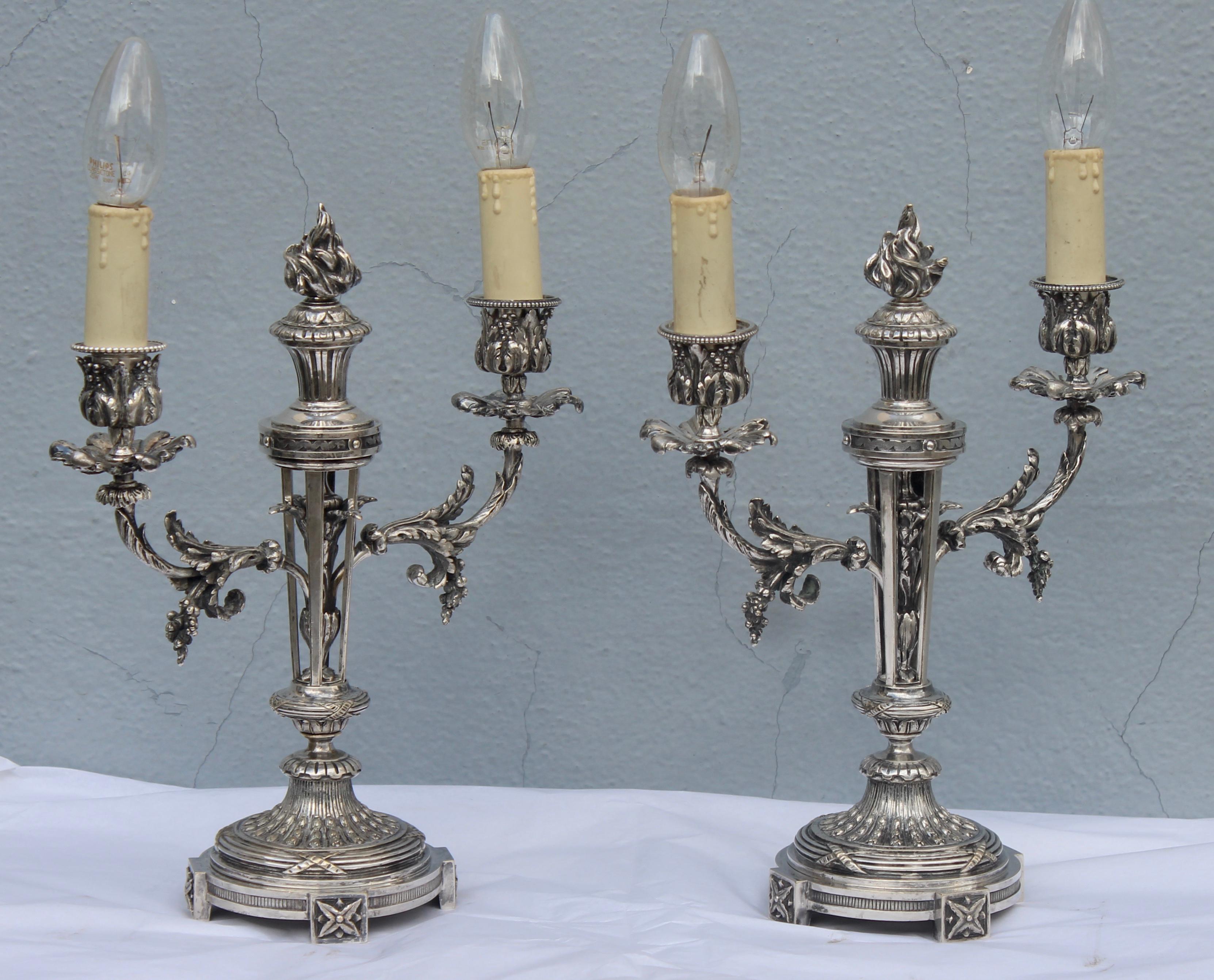 19th century pair of Louis XVI style silvered bronze twin-branch candelabras
the open work stem with flambeau finial
circa 1880.
