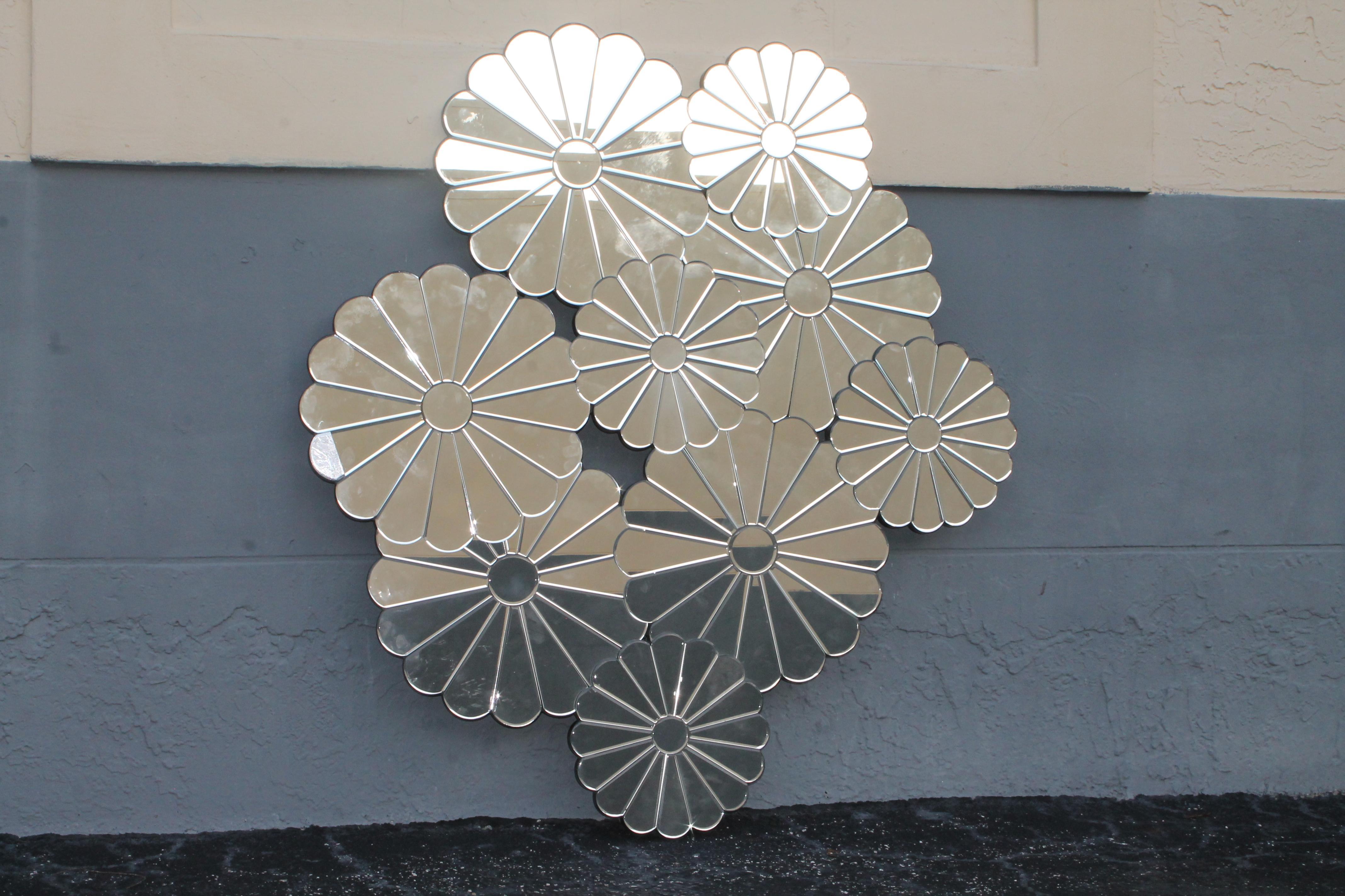 Large 1960s Mid Century Modern Fully Mirrored Flower Blossm Cluster Wall Mirror. This piece was quite a find. Many pieces of artfully placed mirrored flower blossoms. This statement piece can go anywhere.