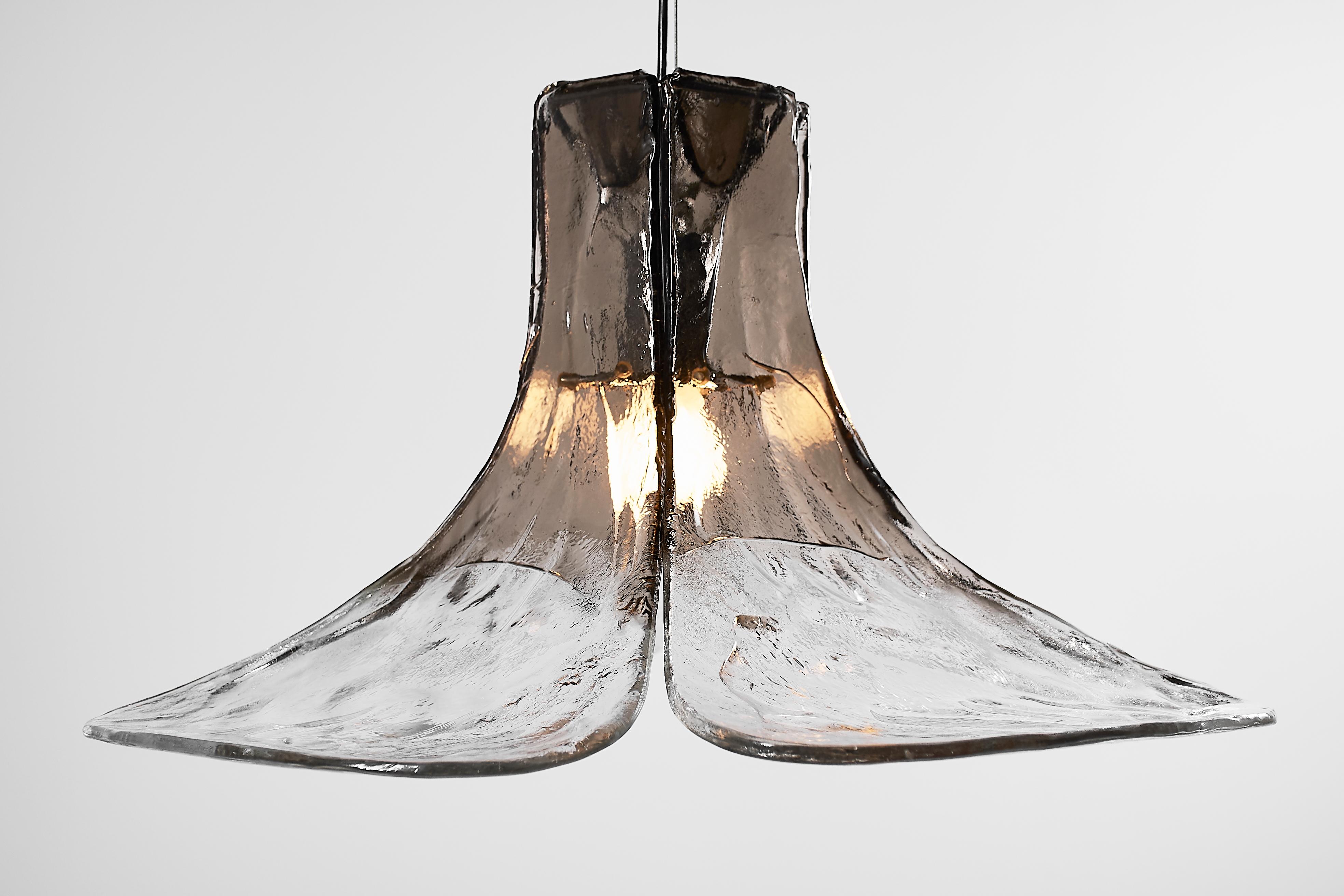 Extra large 1970s Italian Mid-Century Organic Modern floral pendant light. Four large and very thick hand blown clear and smoked Murano glass petals are supported by a metal frame. The petals droop in a concave fashion from the canopy down. They