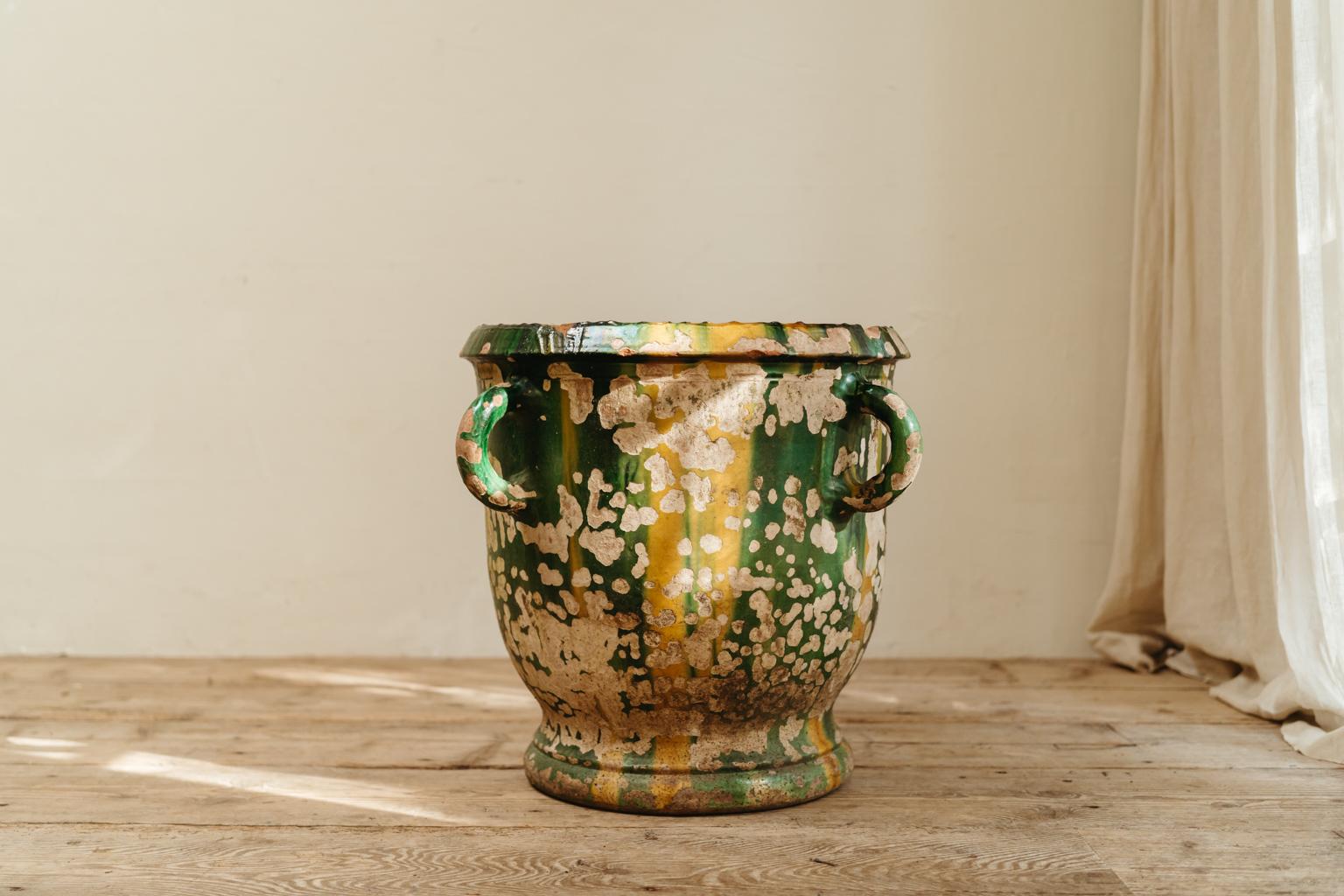 This xl green and yellow glazed terra cotta planter/jardinière from Castelnaudary in the South of France has a wonderful patina, can be used indoors or outdoors, was originally made for a castle garden in the South of France.