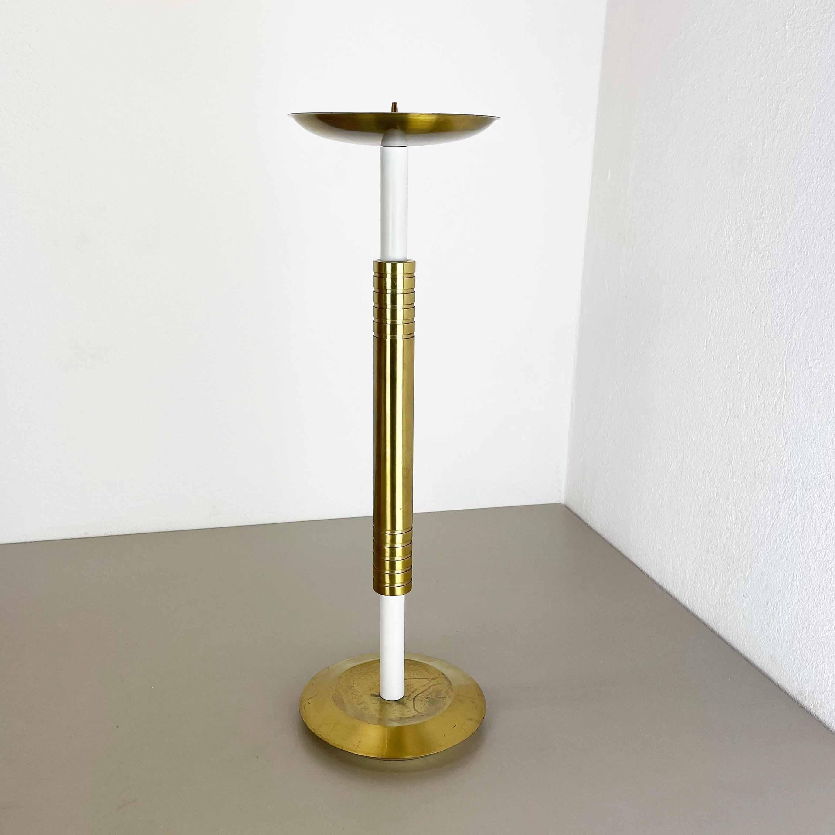 Article: Brutalist floor candleholder

Origin: Italy

Material: brass and metal (white tube stand)

Decade: 1950s

Description: This original vintage candleholder, was produced in the 1950s in Italy. it is made of solid brass and metal, and