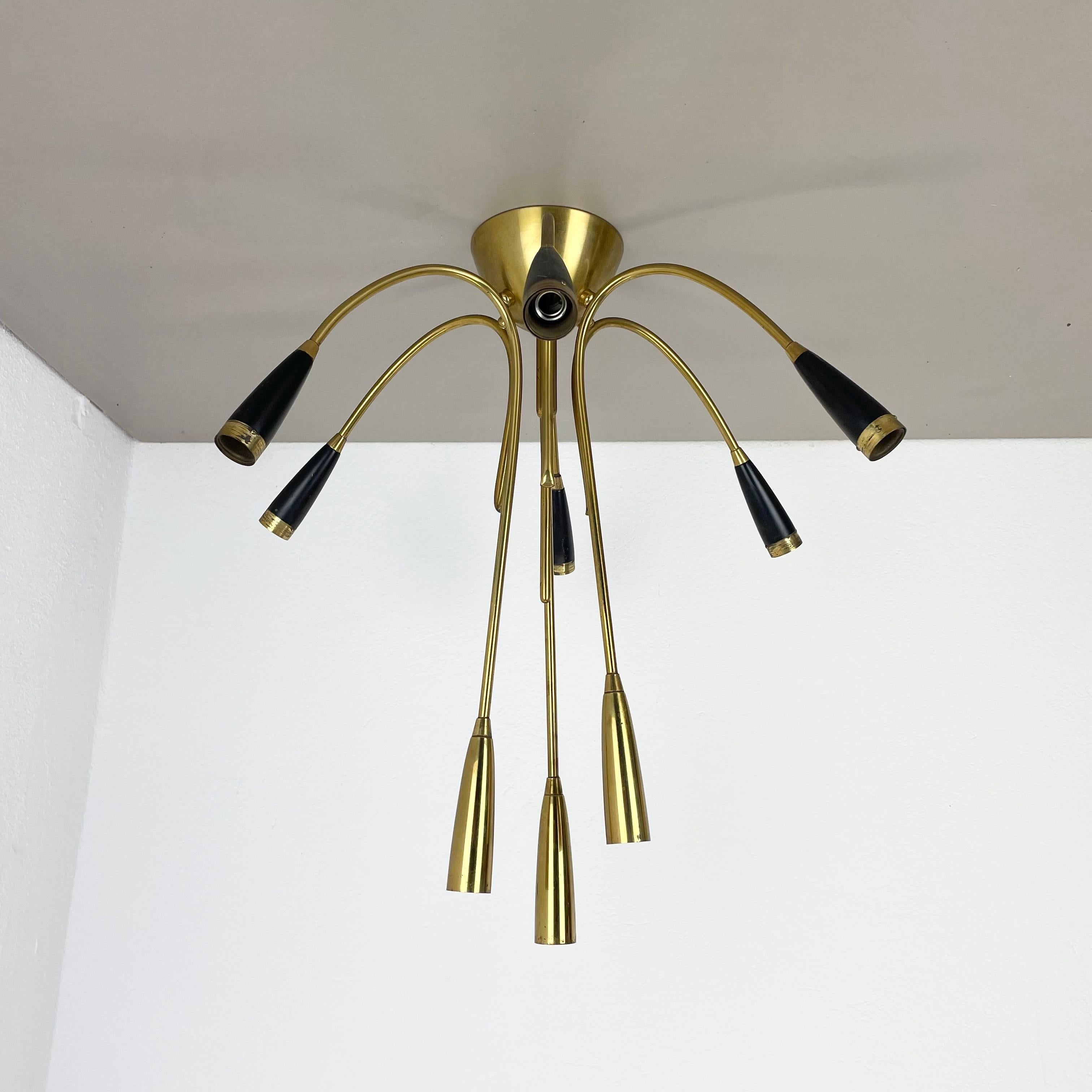 Article:

brass ceiling light, flush mount



Origin:

Italy



Age:

1950s



This vintage modernist light was produced in the 1950s in Italy. The lights is made of metal and solid brass with 9 huge light arms with bulb sockets on the ends. the