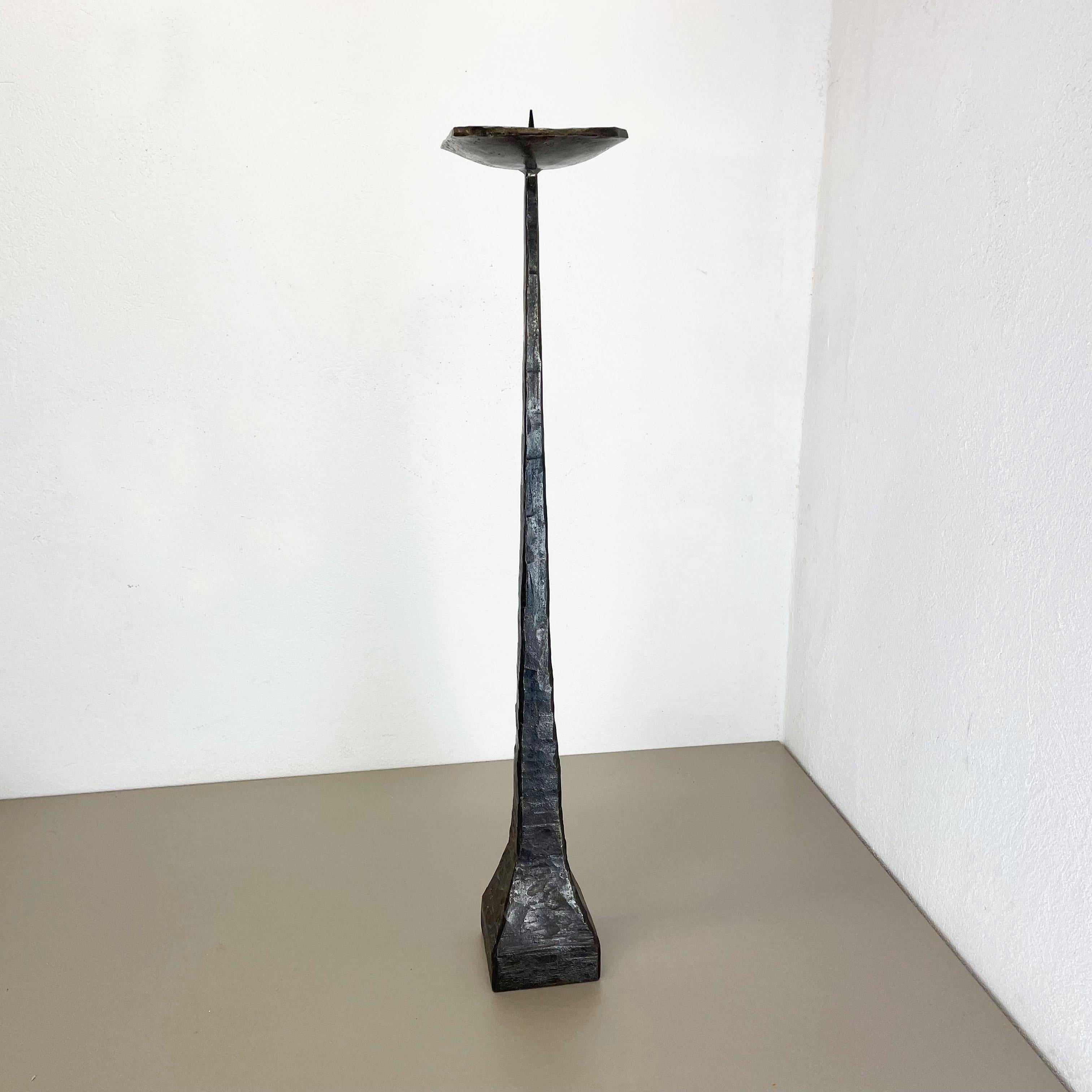 Article: Brutalist floor candleholder

Origin: Germany

Material: Solid metal

Decade: 1970s

Description: This original vintage candleholder, was produced in the 1970s in Germany. it is made of solid metal, and has a lovely patination due