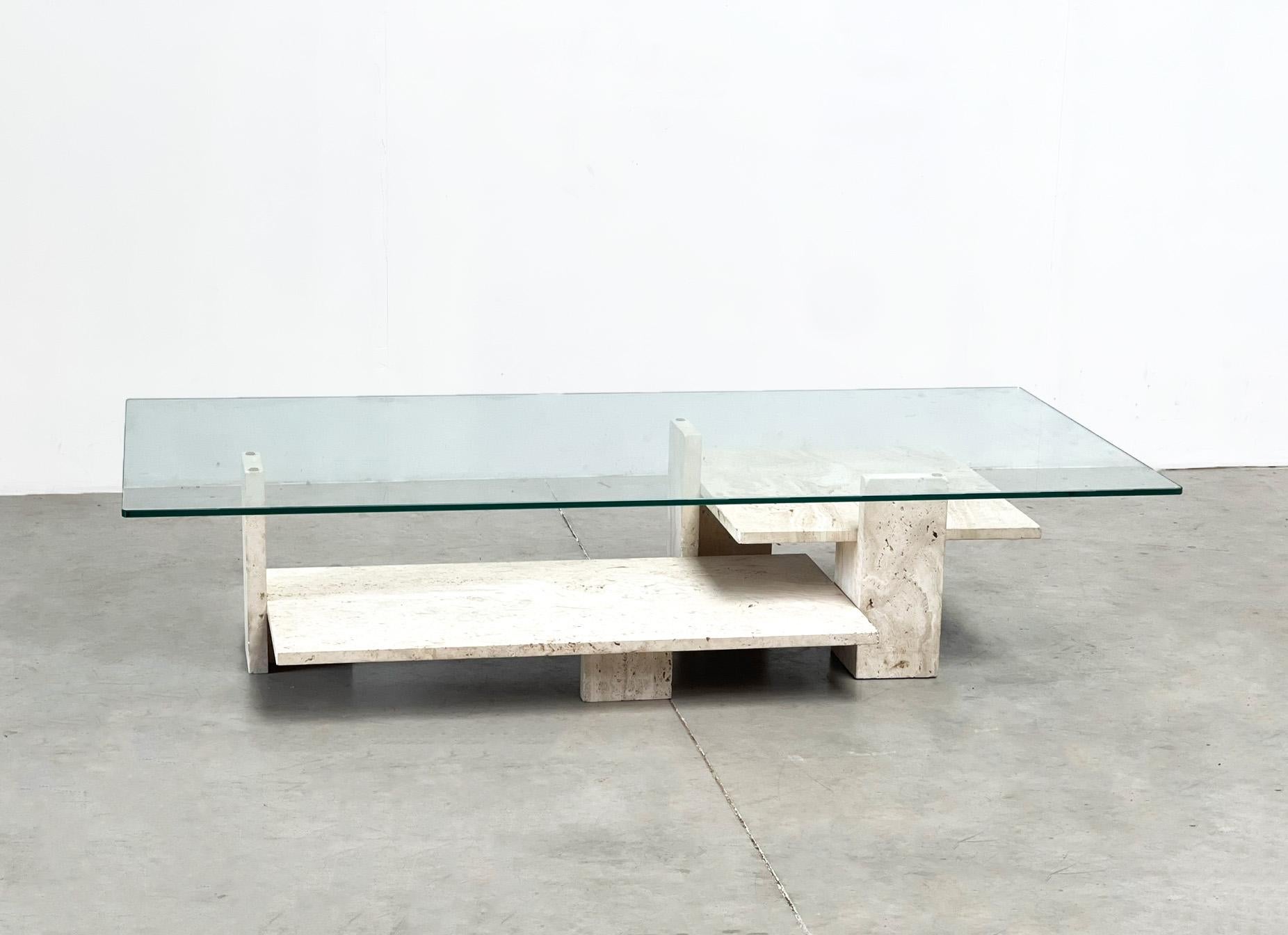 Xl Willy Ballez coffee table
This sculptural coffee table was created by Belgian artist and architect Willy Ballez.

The table was made in the 80s in Belgium.

It features a glass top and a travertine base that consists of 2 parts. The large version