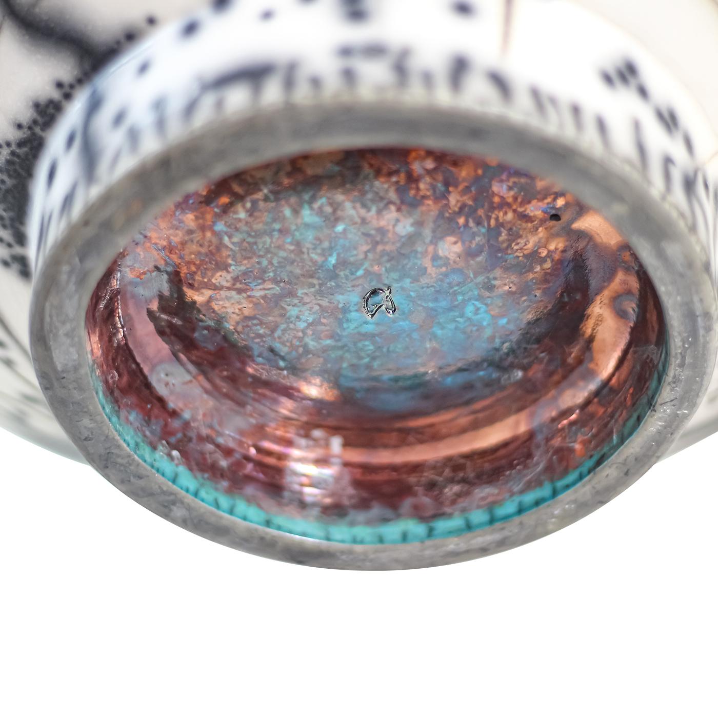 Decorative ceramics bowl made with the Naked Raku and Raku technique. The bowl is created by a press mold technique and then finished off on the wheel to give a nice and smooth touch. A Raku medium-size-crackle turquoise glaze is applied inside the