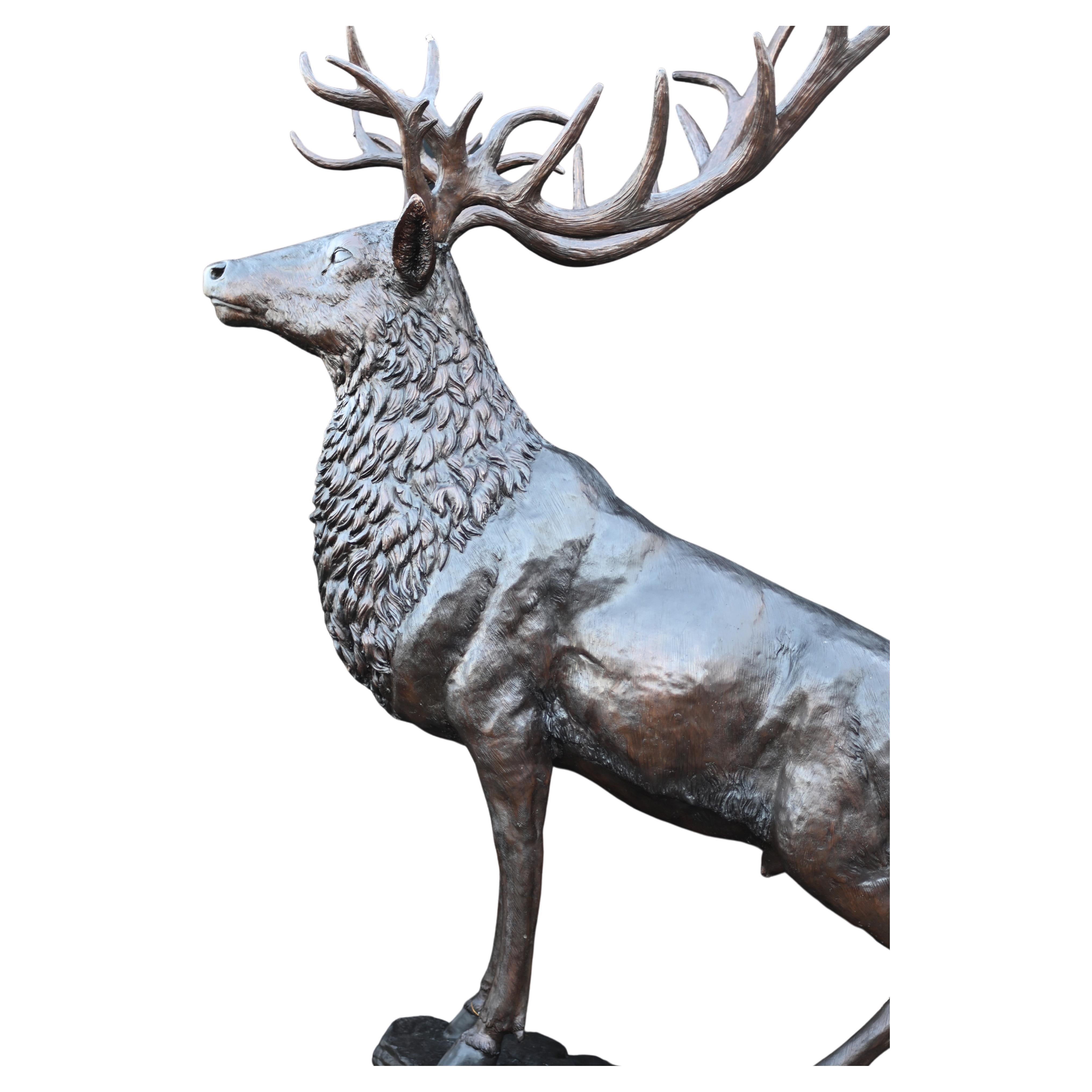 From time to time we find some really big pieces and this is right up there! A giant - almost ten feet tall (292 CM) bronze stag And what a beauty she is standing on the rocky outcrop like a Monarch of the Glen Large antlers and a great patina to