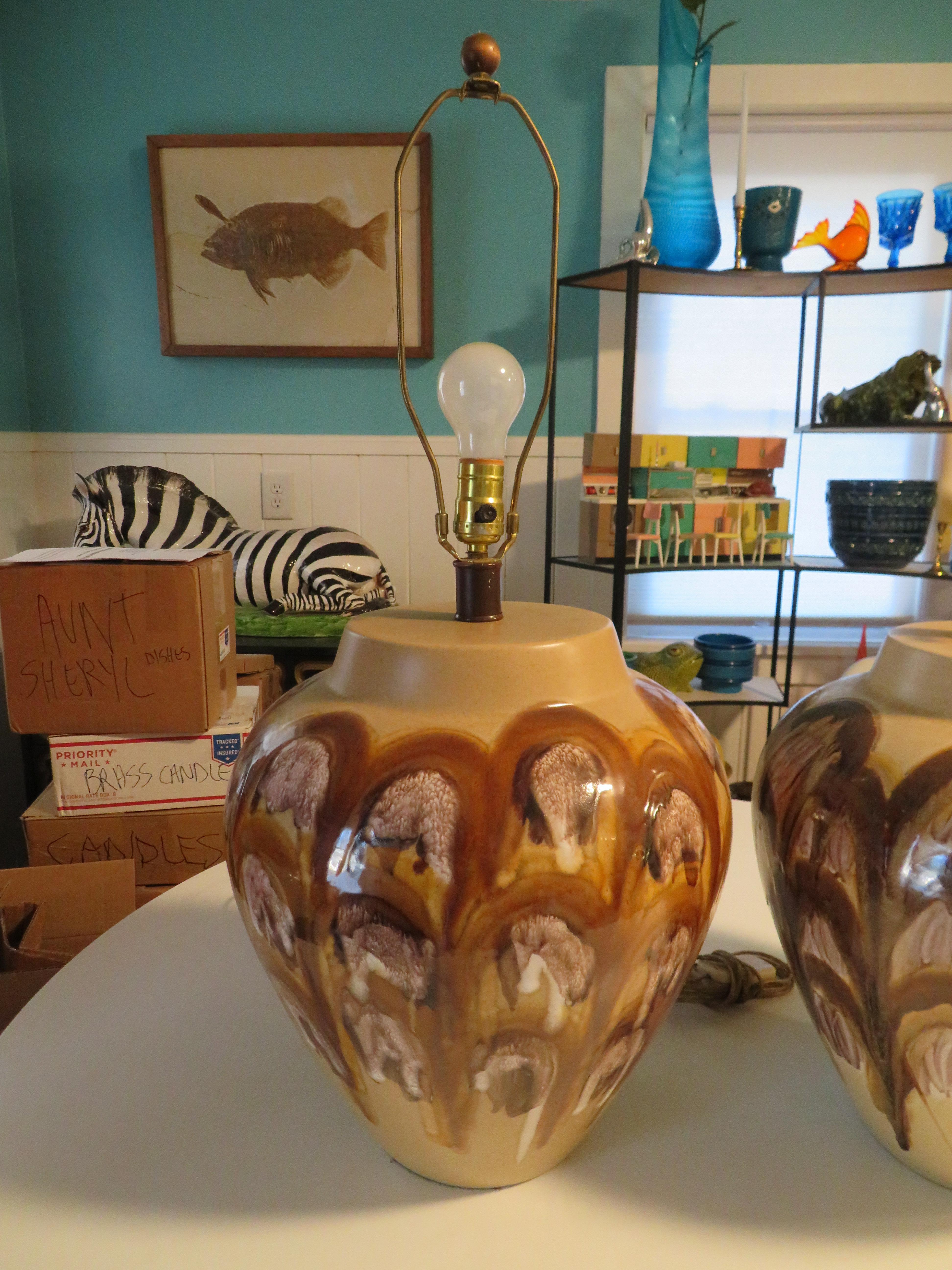 Beautiful extra large pair of drip glaze pottery midcentury lamps. This pair measures 30” tall x 14” wide with the pottery height about 15”. This pair is a close match with slightly different shades of brown abstract designs-one is more caramel and