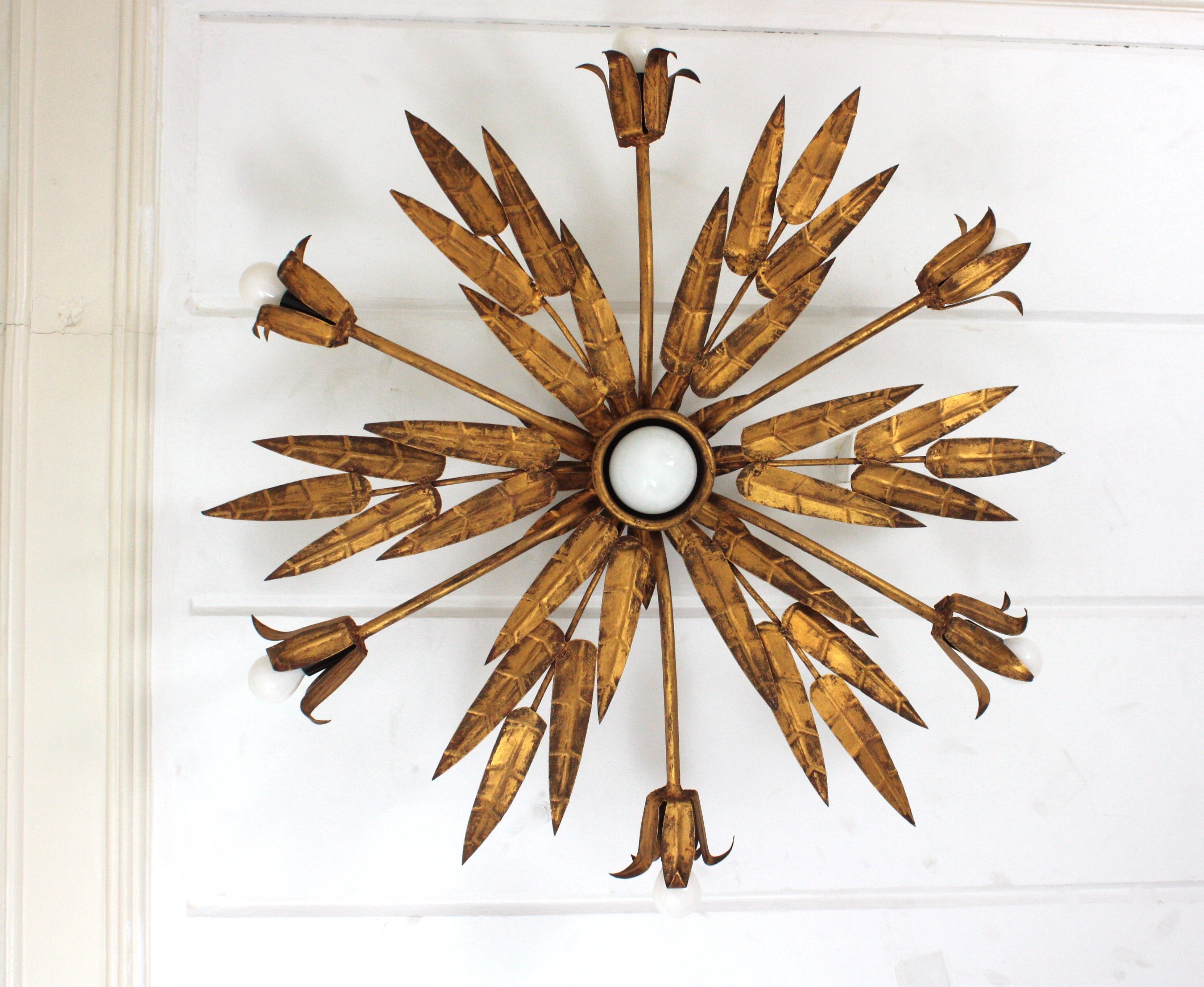 XL Spanish Foliage Floral Sunburst Chandelier in Gilt Wrought Iron with 7 Lights.
Manufactured by Ferro Art. Spain, 1950.
Large Size.
Seven Lights in total.
One of a kind Foliage Floral Chandelier / Flush Mount Ceiling Light in gilt patinated