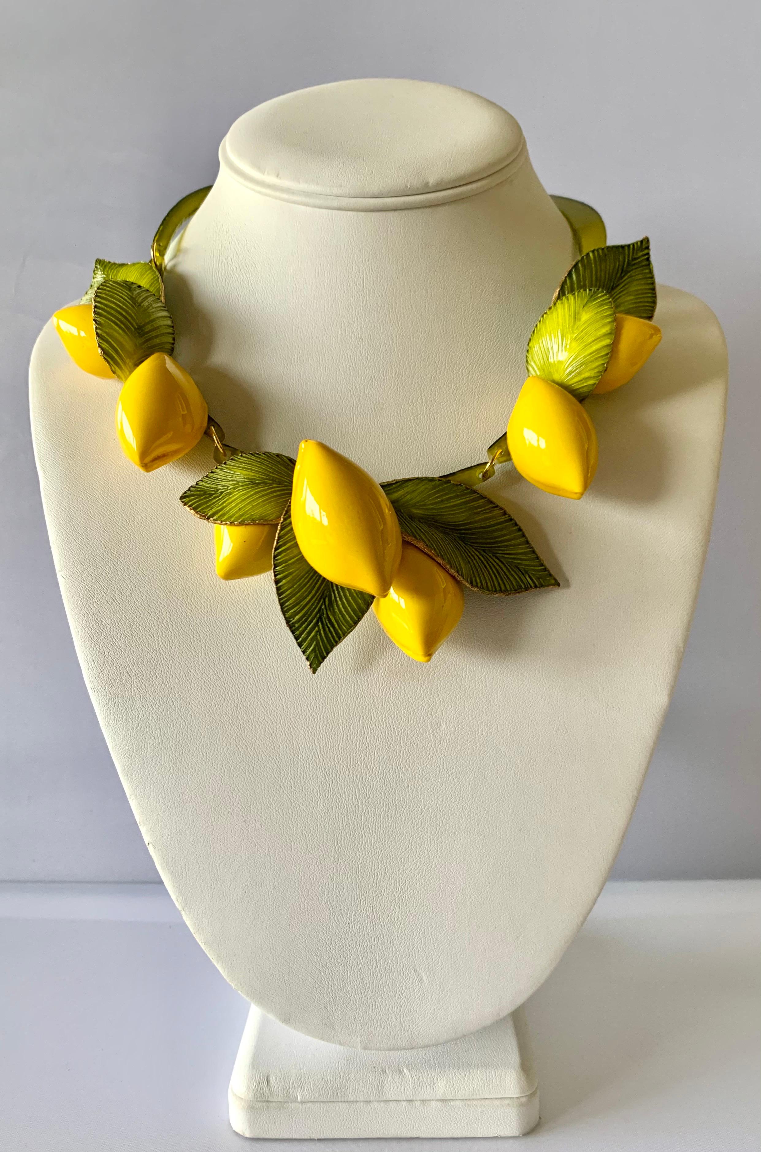 Contemporary fashion-forward giant lemon statement necklace - the bold necklace is comprised out of a row of highly adorned enameline (resin and enamel) yellow lemons. The oversized lemons feature hand-manipulated and etched acrylic details.