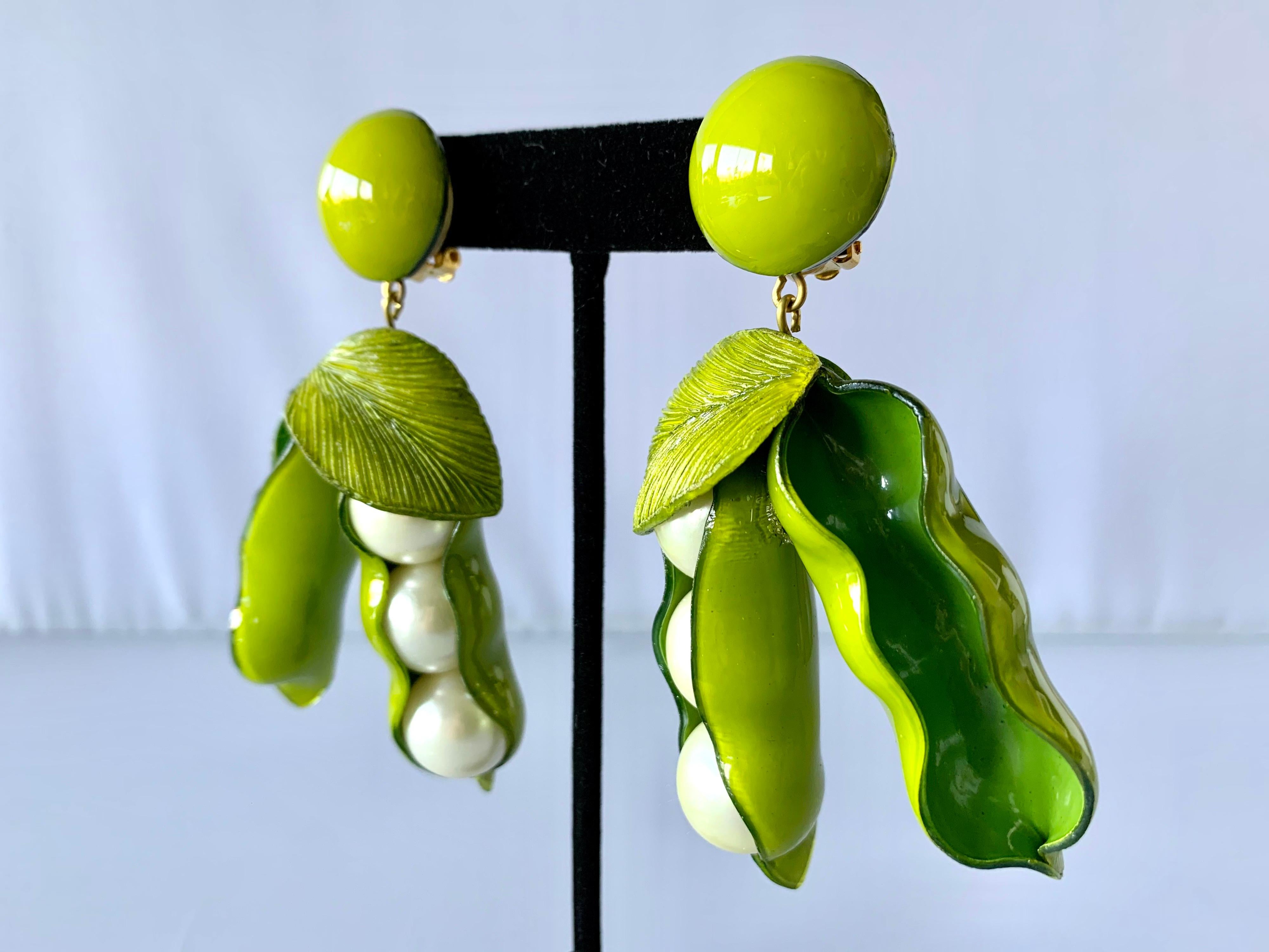 Contemporary handcrafted artisanal clip-on Statement earrings made in Paris France by Cilea Paris - lightweight, featuring two large peapods. The peapods are comprised out of green resin and enamel and have large faux pearls at the center.