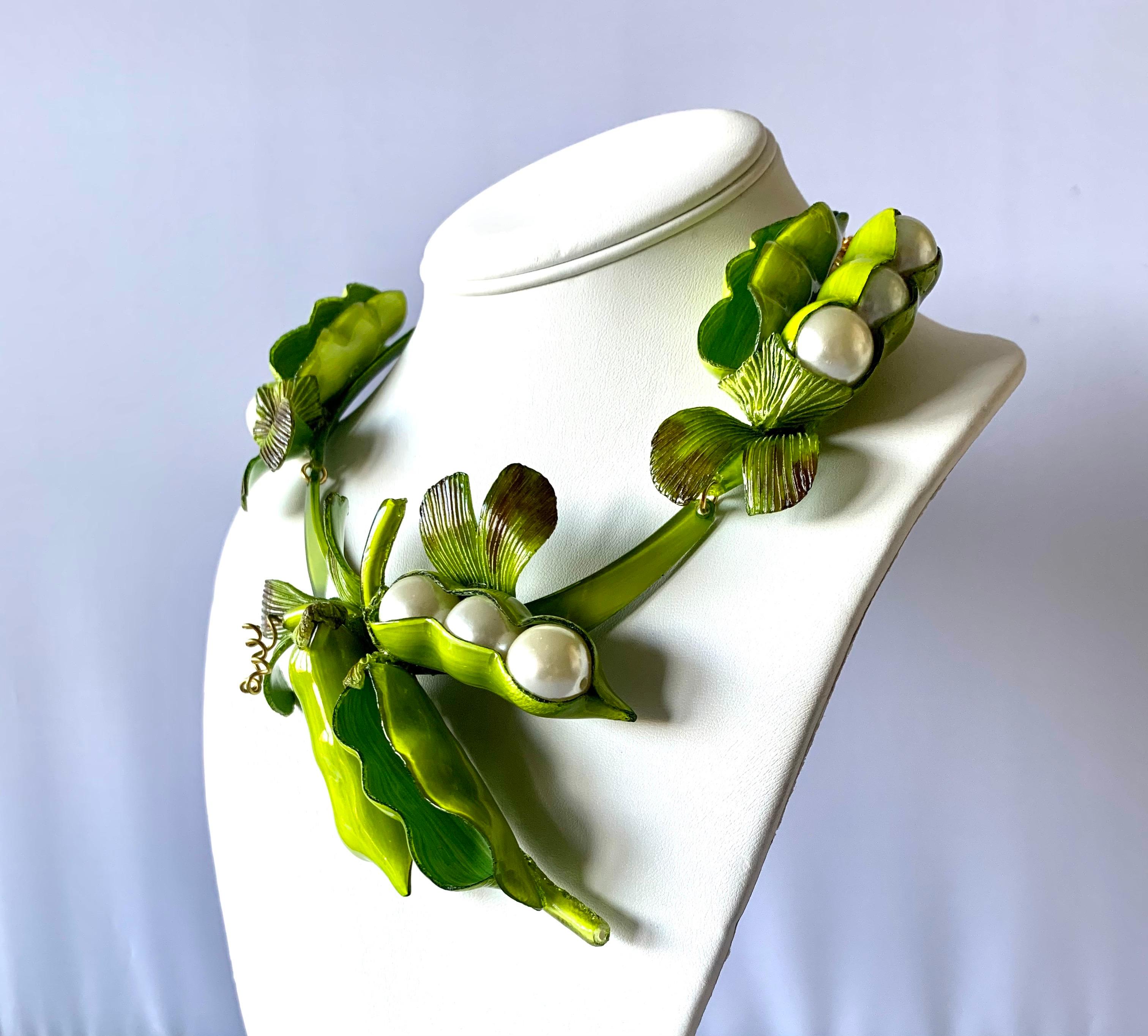 Contemporary designer giant peapod statement necklace - the bold necklace is comprised out of a row of highly adorned enameline (resin and enamel) peapods. The oversized peapods feature hand-manipulated and etched acrylic details and large white