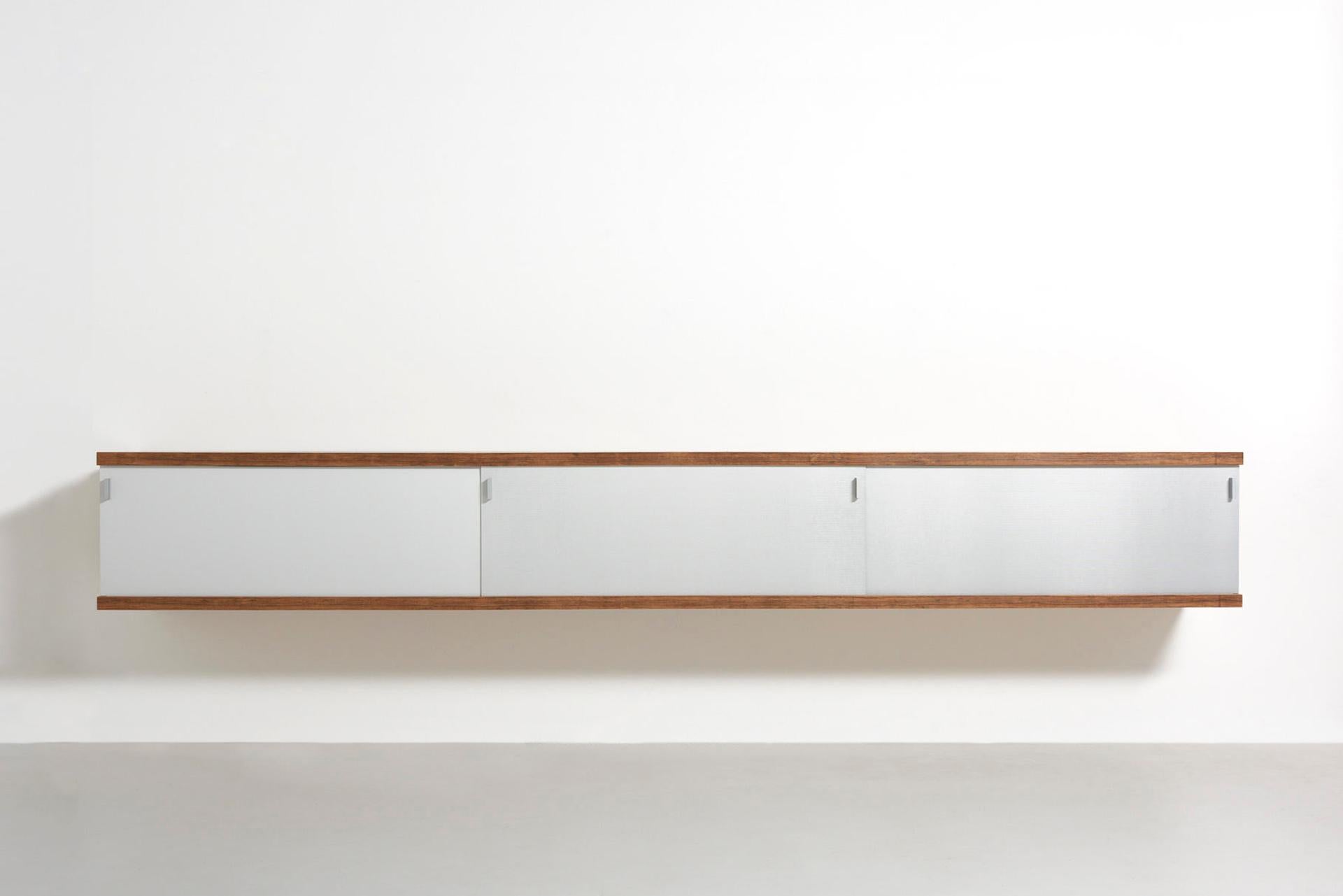 An extra large floating sideboard in rosewood with three sliding doors in ribbed aluminium. This edition is even 20cm longer than the standard long version. Designed by Horst Brüning in 1967. Made by Behr in Germany.

