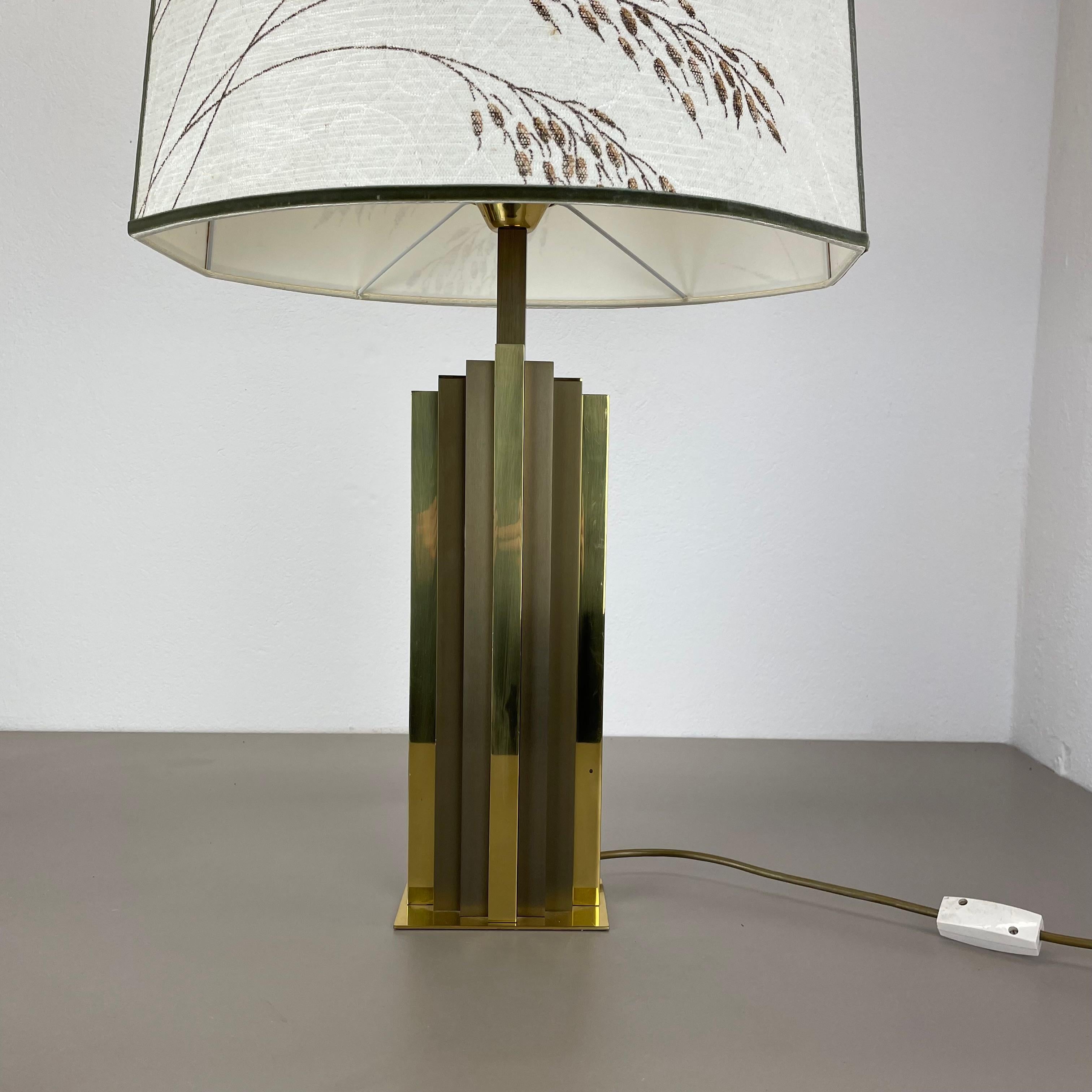 Article:

modernist brass table light with original shade


Origin:

Italy


Decade:

1970s



This original vintage light was designed and produced in the 1970s in Italy. The light is made of brass and metal which gives the light base a bicolor