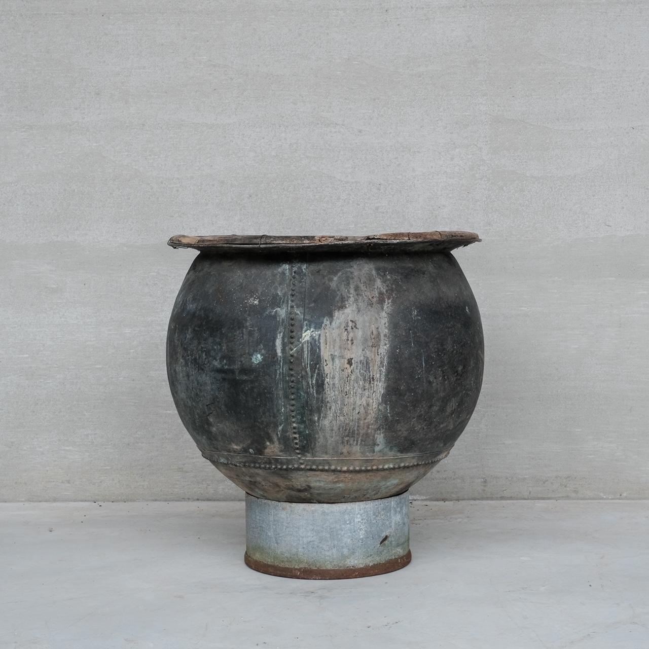 An impressive early 20th century riveted vat or planter. 

Unusual wooden surround to the top adds character. 

France, c1920s. 

Later addition of a ciruclar metal base to provide support but this could be removed as it is not joined, if the