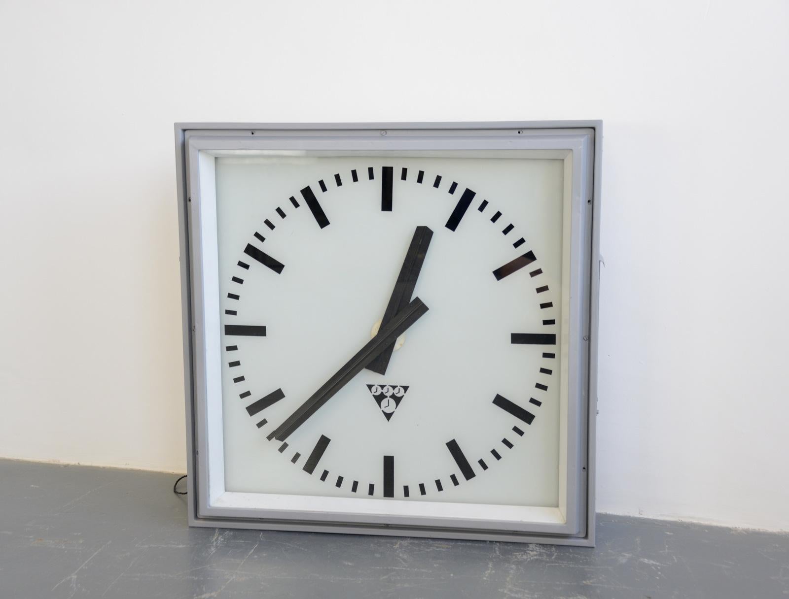 Extra large light up station clock by Pragotron, circa 1950s

- Glass face and dial
- Steel casing
- Takes 4x E27 fitting bulbs
- New AA battery powered quartz motor
- Czech, 1950s
- Measures: 96cm wide x 96cm wide x 22cm