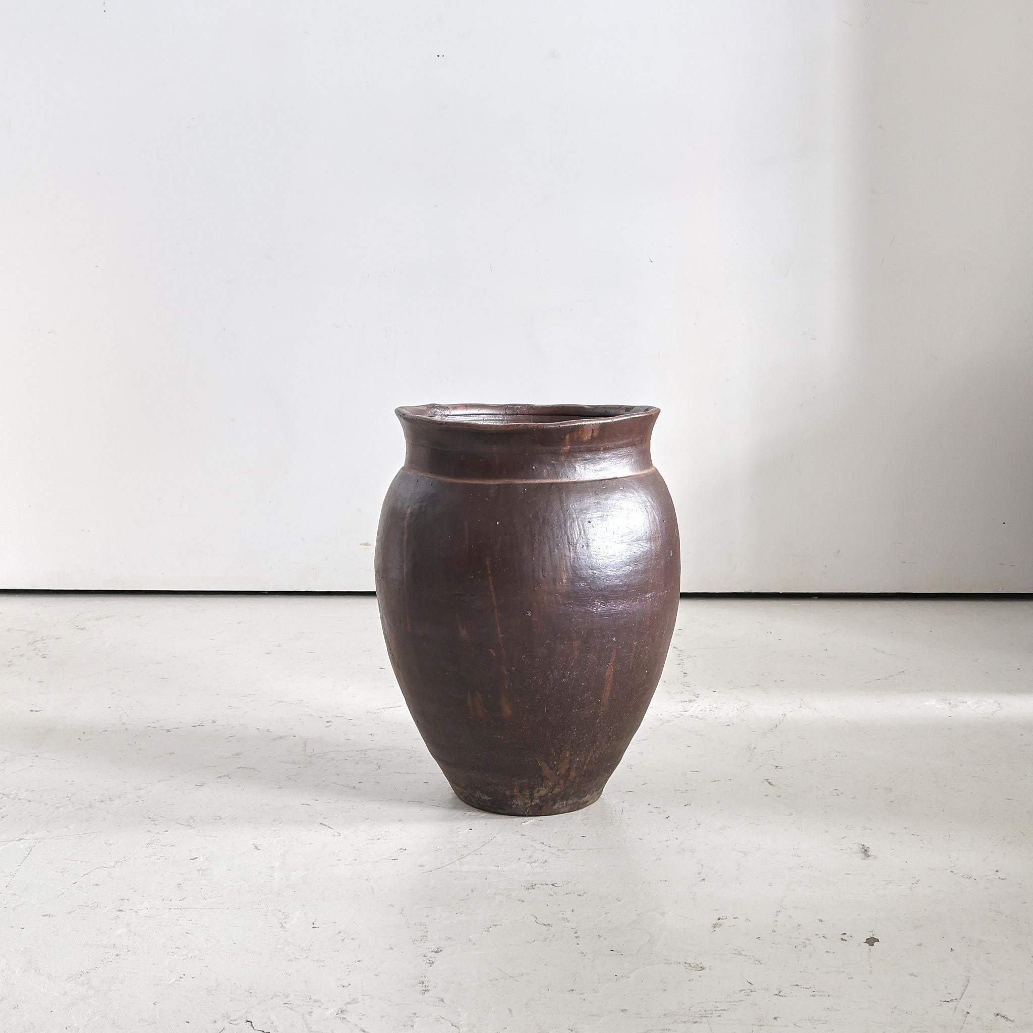 An XL mid 19th century Japanese terracotta vessel originally used for the storage/transportation of either alcohol or oil.

Due to its utilitarian past it has developed a rich patina over the 100 + years of regular use..
