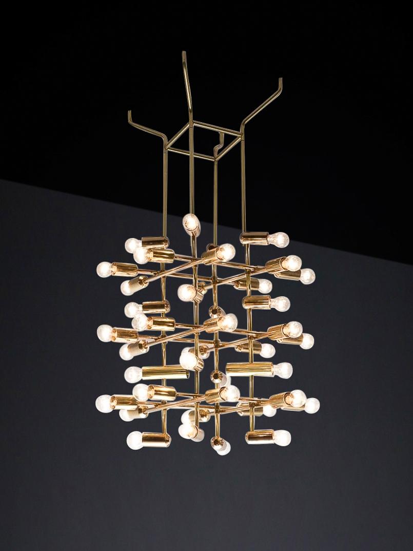 Mid-Century Brass Chandelier wit 40 lights, Switzerland 1960s.

A large mid-century chandelier made of brass was manufactured in Switzerland in the 1960s and is now available in Europe. The chandelier has a unique design consisting of a brass