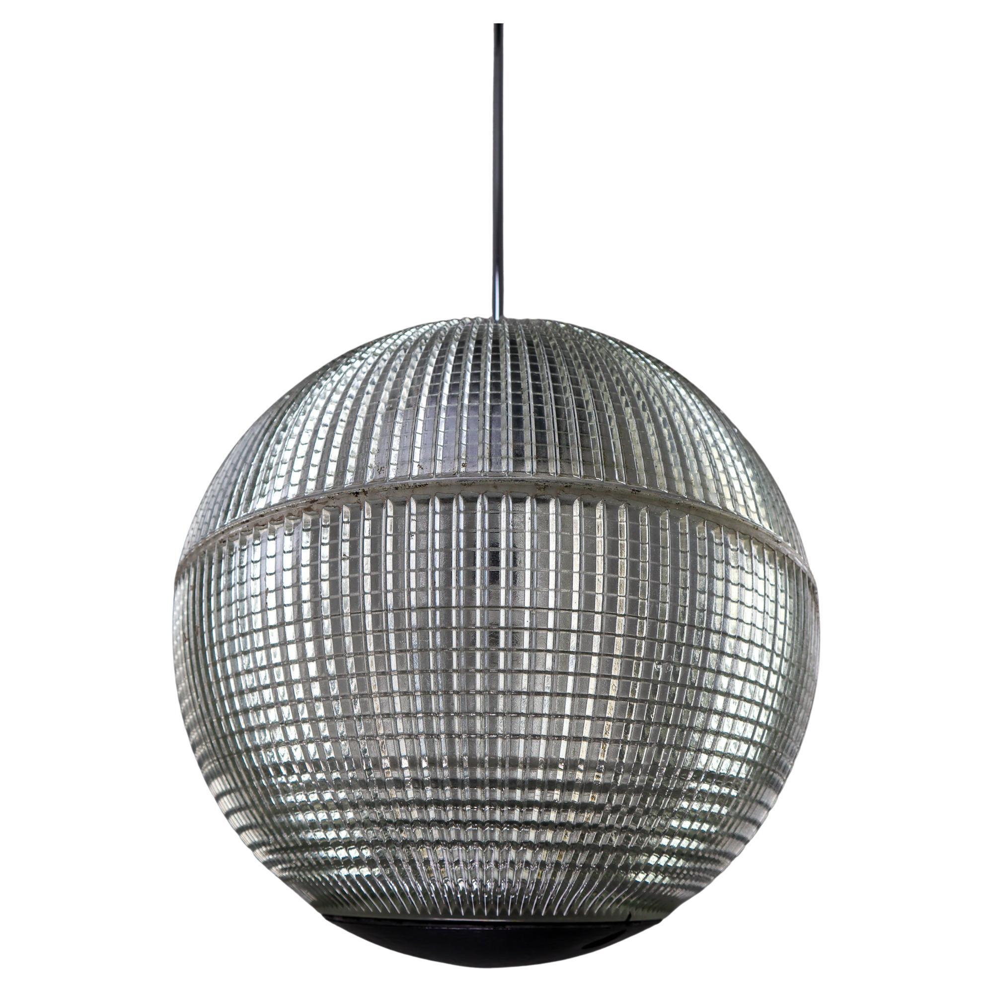 This is a large original late 1960s Paris globe Holophane Street light from Paris, France now turned into a pendant light. The hallmark of Holophane luminaries, or lighting fixtures, is the borosilicate glass reflector / refactor. The glass prisms
