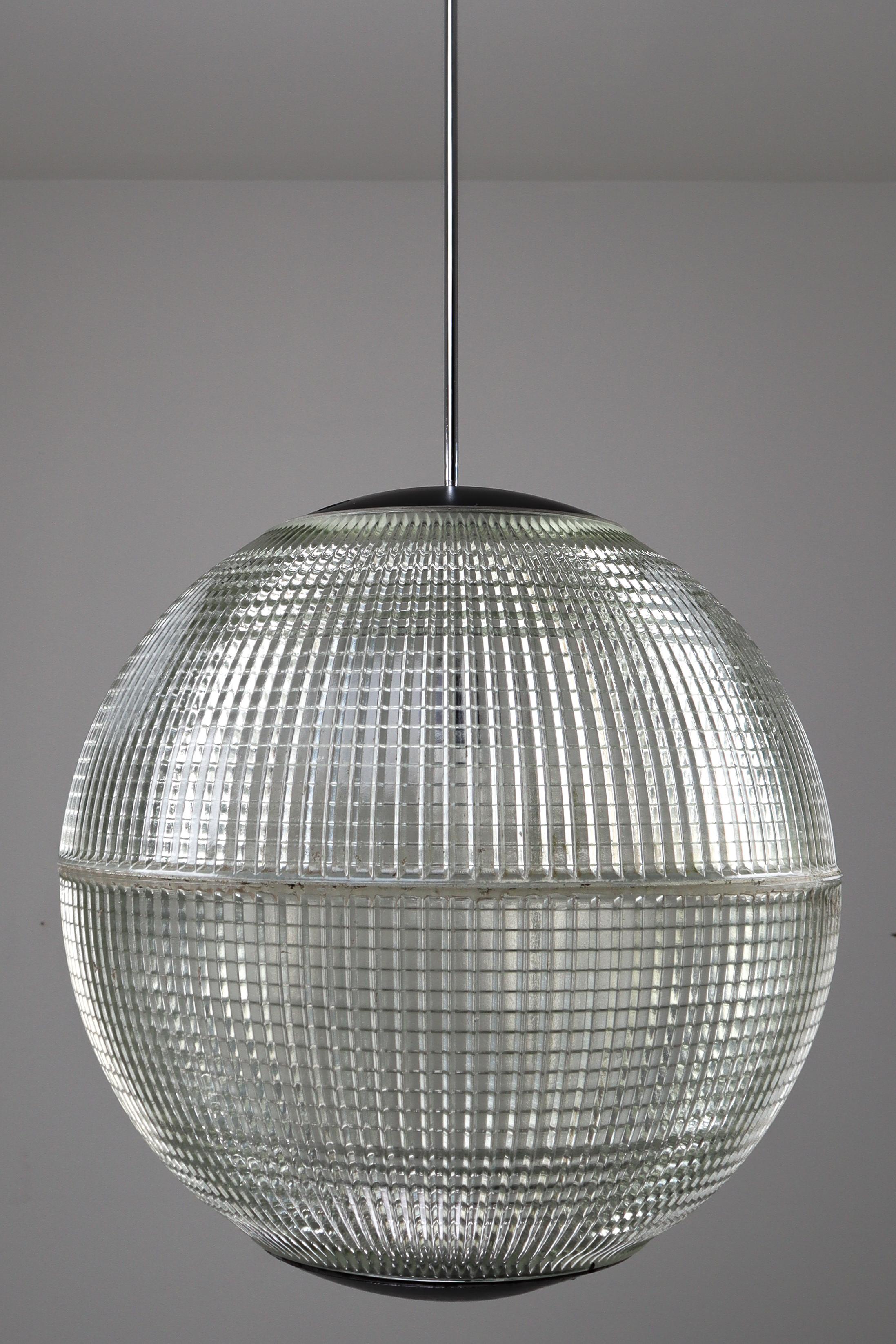 This is a large original late 1960s Paris globe Holophane Street light from Paris, France now turned into a pendant light. The hallmark of Holophane luminaries, or lighting fixtures, is the borosilicate glass reflector / refactor. The glass prisms