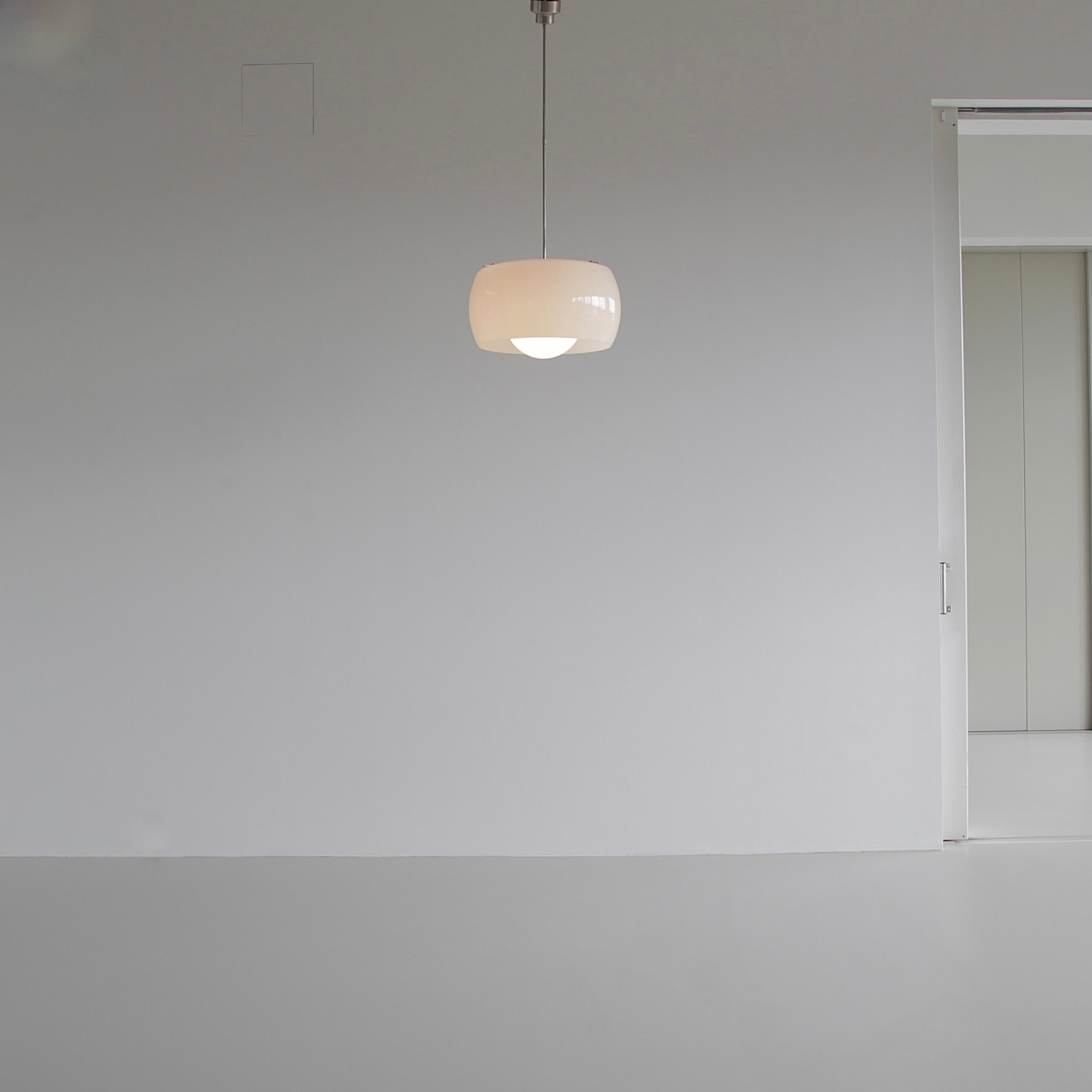 Hanging lamp designed by Vico Magistretti. Italy, Artemide, 1962.

The XL size Omega lamp comprising of two separate pieces of opaline glass on a brushed metal frame. 

We also have the normal size version (40 cm) available

Literature: Artemide