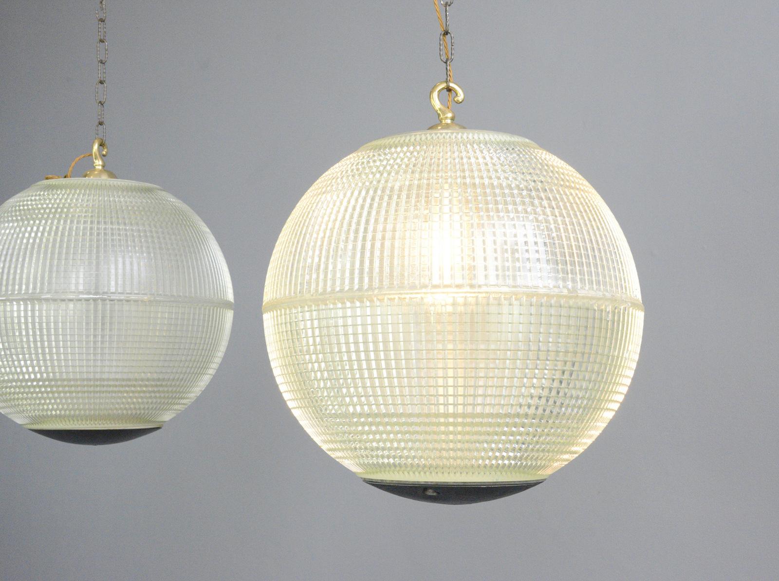 Extra large Parisian Holophane globe lights, circa 1950s

- Price is per light
- Heavy prismatic glass 
- Comes with chain and ceiling hook
- Takes E27 fitting bulbs
- Originally used on the tops of street lamps across Paris
- Made by