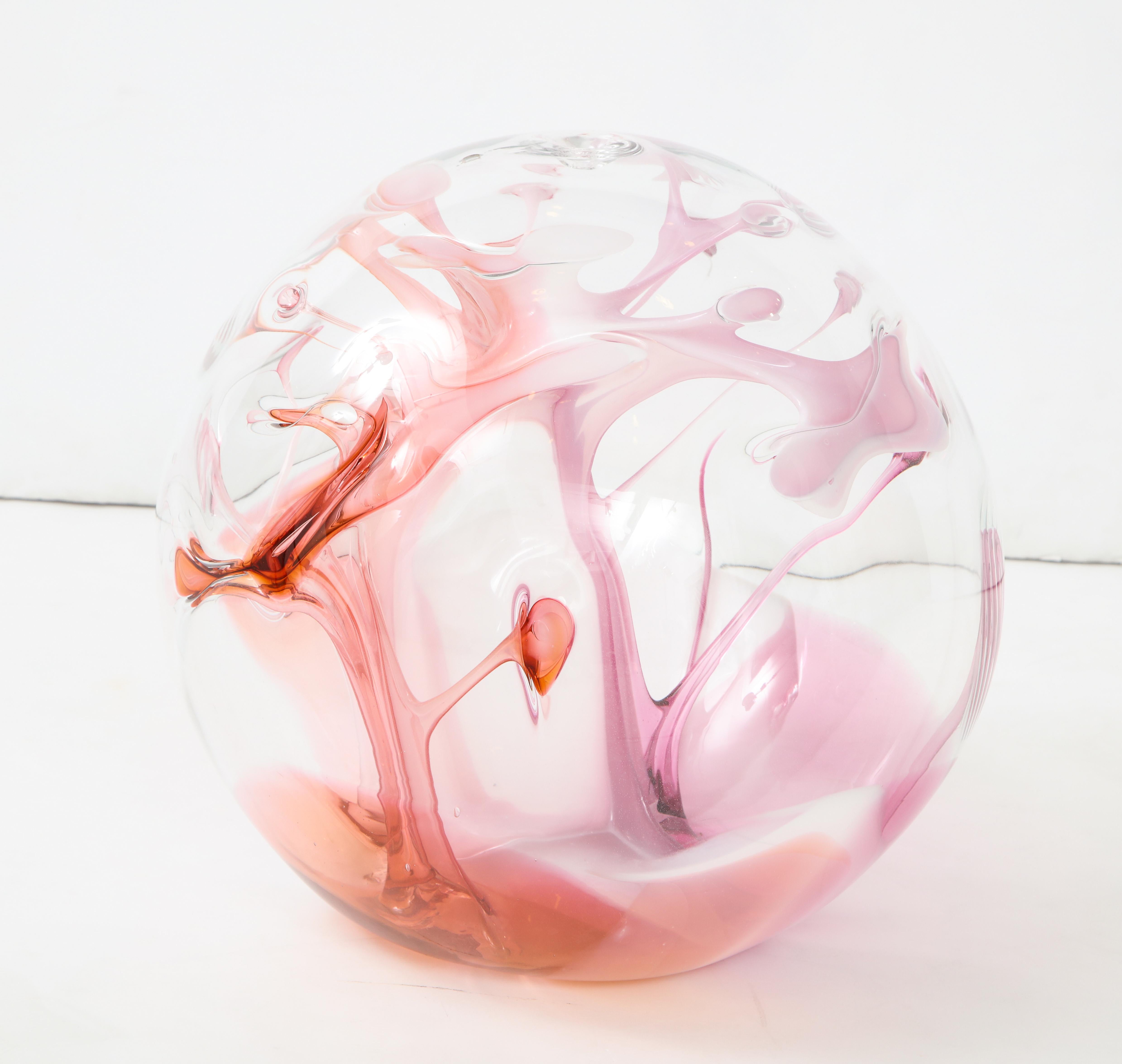 Extra larger signed and dated Peter Bramhall July 1987 glass orb sculpture
with internal glass threads of pink, red and mauve.