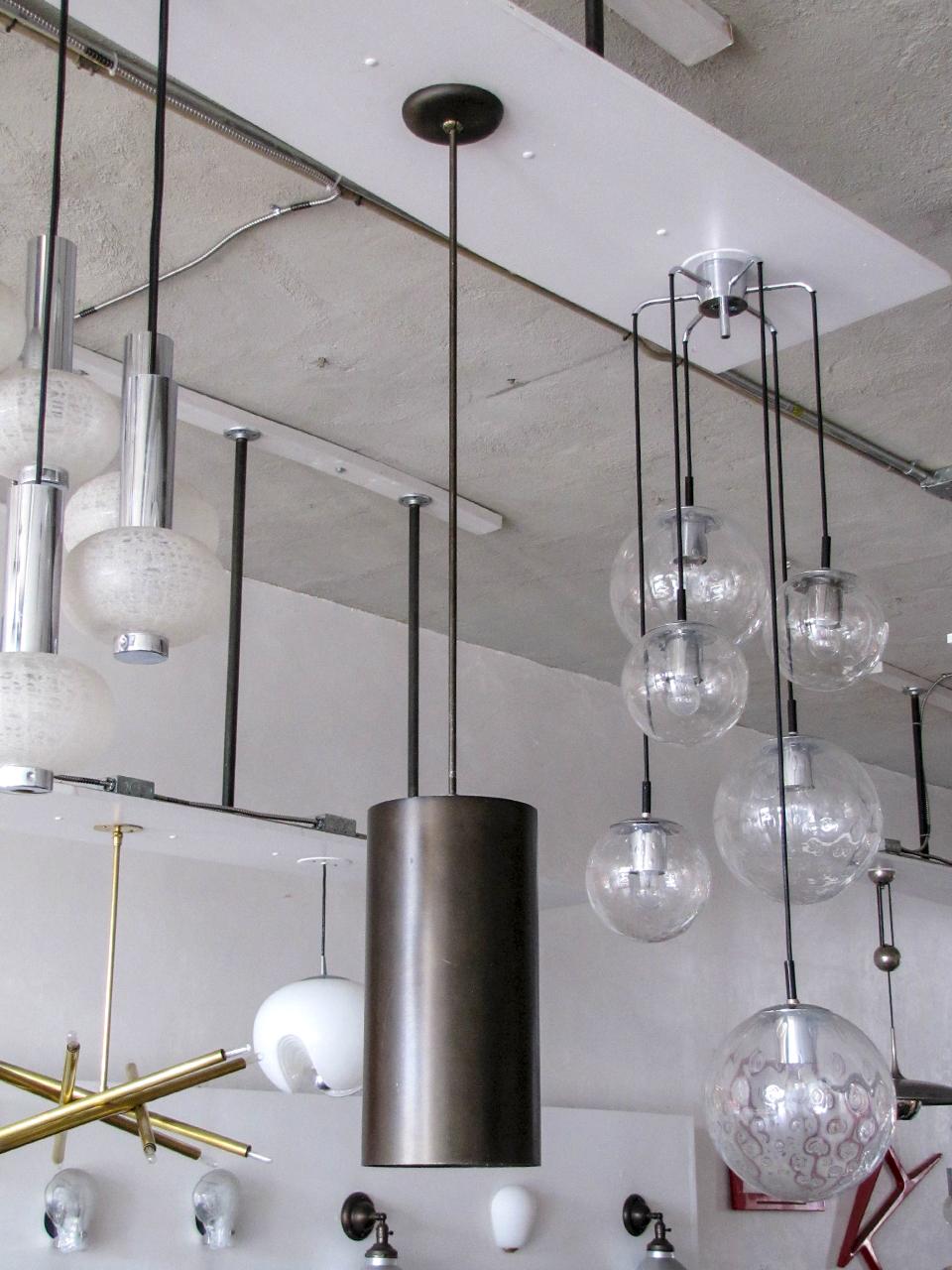 Wonderful extra-large scale cylindrical pendants in black/olive colored brushed anodized aluminum pendants by Prescolite, formerly used in a church setting, total drop = 54 inches, can be customized. Wired for US standards, one E26 socket per