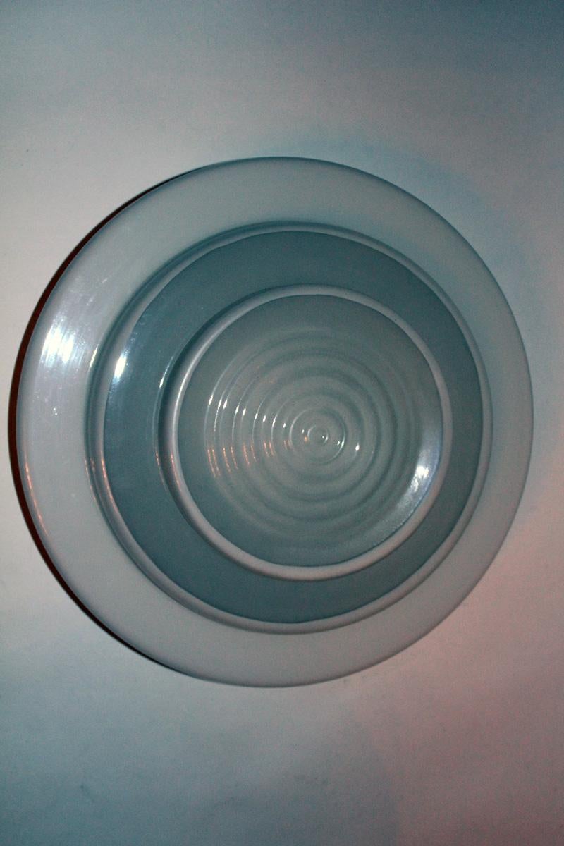 An extremely large ceiling light with frosted and white glass shade and an aluminum mount.