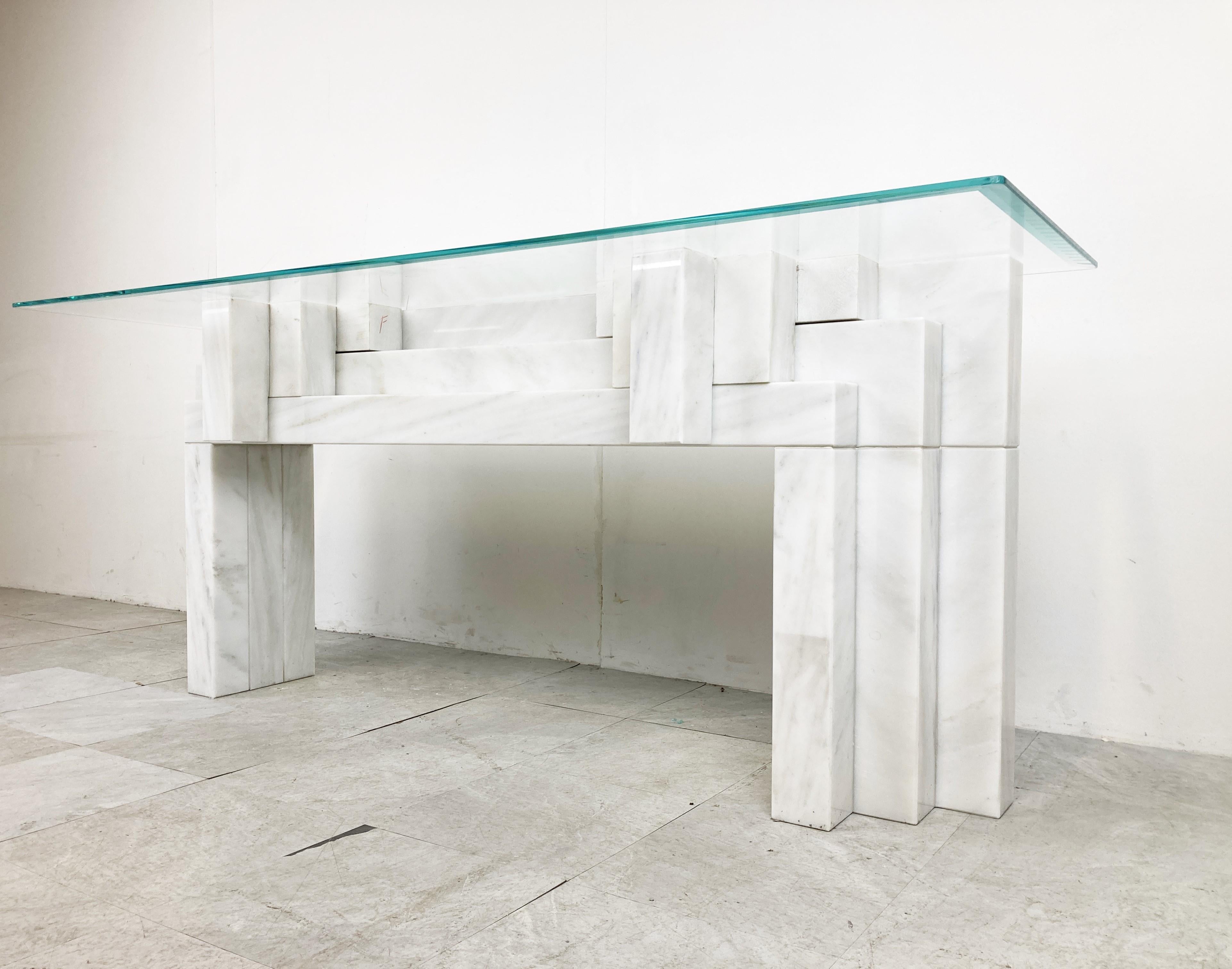 Stunning architectural white marble console table.

This solid marble console has a nice architectural stepped design.

The base is very very heavy and is made of very high quality white marble.

Glass can be customized to your desired