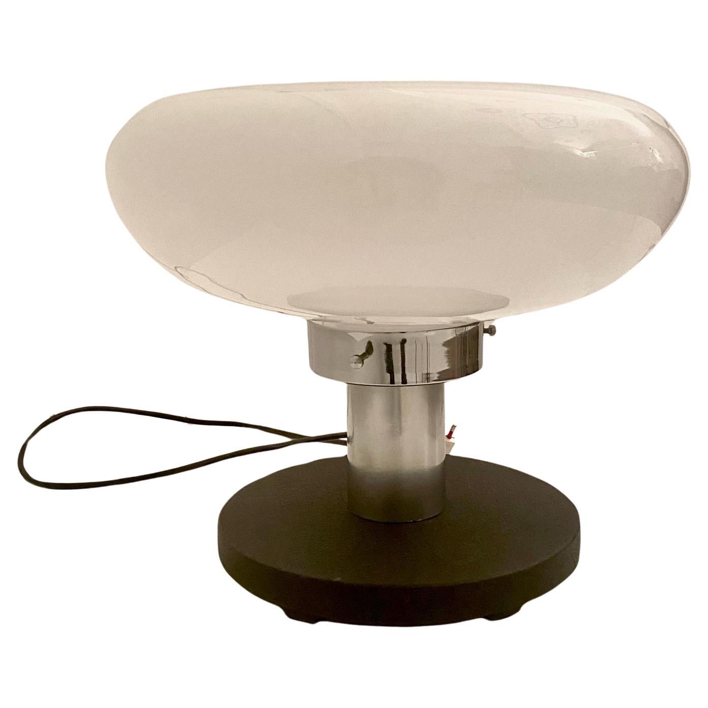 Big Space Age Murano Table Lamp in the style of Artemide, / Mangiarotti manufactured in Italy in the 1970 's

Transparent and white murano glass lampshade set on a round steel base. Special switcher made by a metal chromed lever. Chromed steel pole.