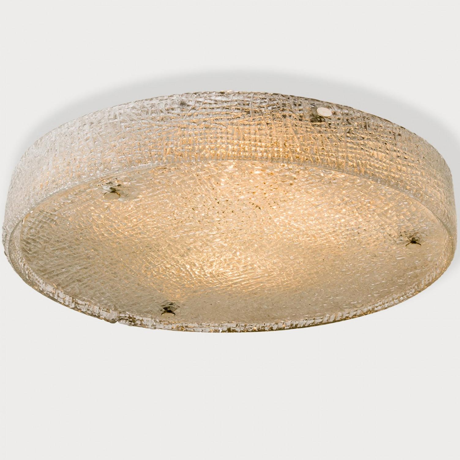 Mid-Century modern textured ice glass light fixtures by manufacturer Kaiser, circa 1965.  Clean simple but high-end design. Illuminates beautifully. Each light fixture, often mistakenly attributed to Kalmar, features a huge handmade thick textured