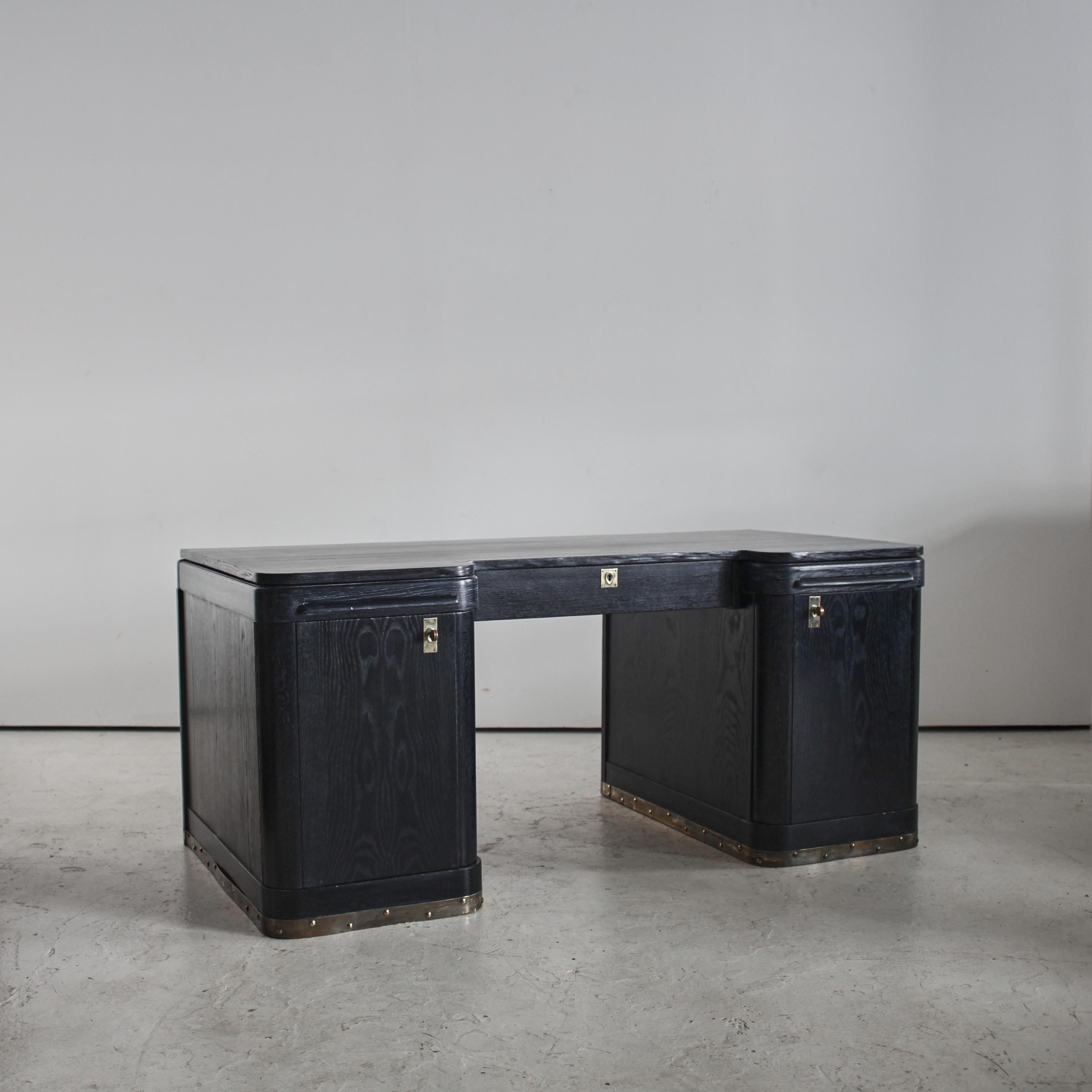 A large C.1930s Austrian modernist desk of the successionist movement

Ebonised cerused oak veneer with original brass hardware.

Removed from a home in central Vienna.

Similar in style to key designers of the time, Josef Hoffmann & Otto