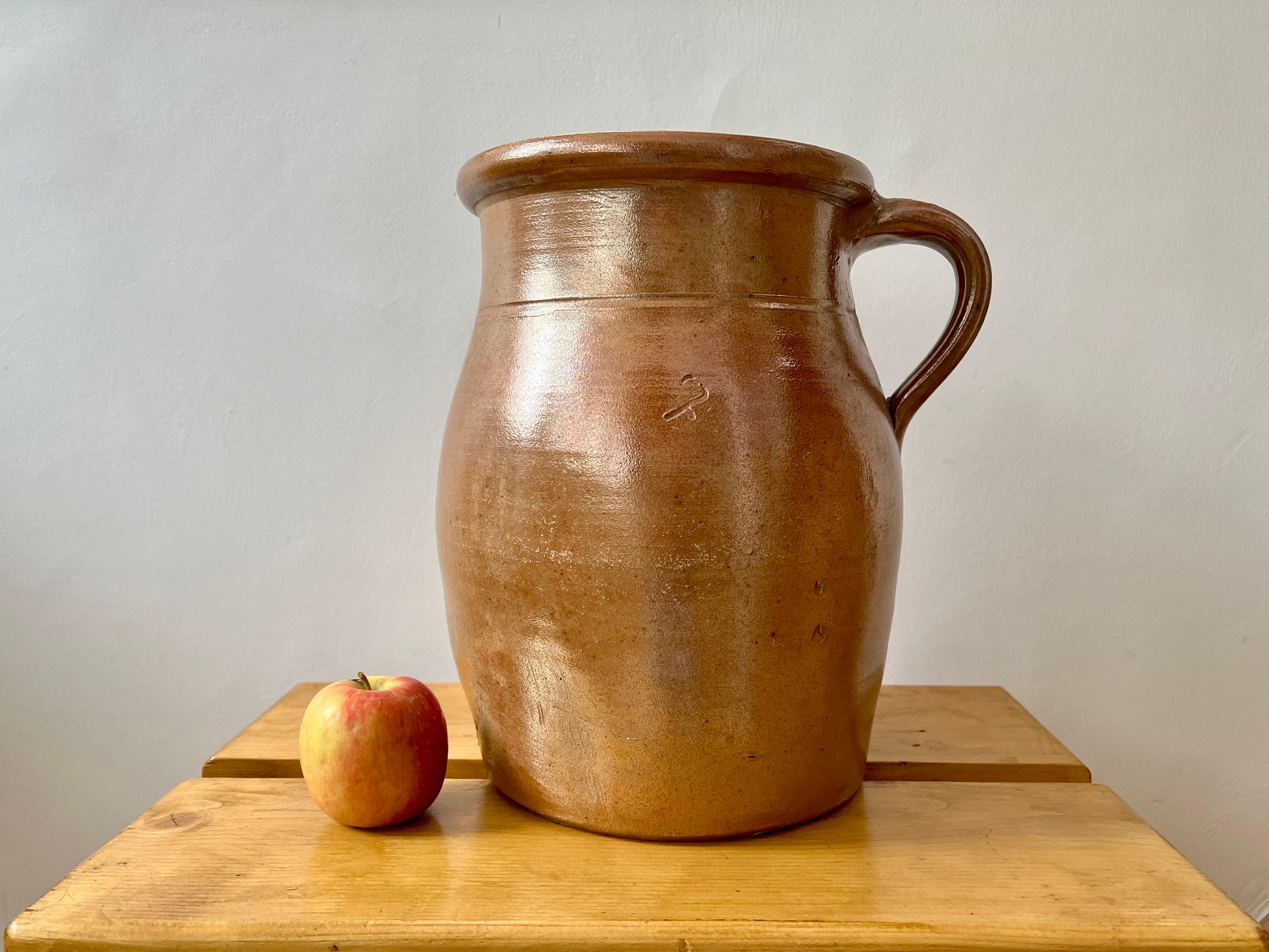 Really good large size, vintage rustic French stoneware jug.

Sourced from central France.

Hand thrown with a warm glazed finish. Marked with a number 7 (7 litre capacity).

Lovely decorative item, ideal for use as a vase for bouquets, plants,