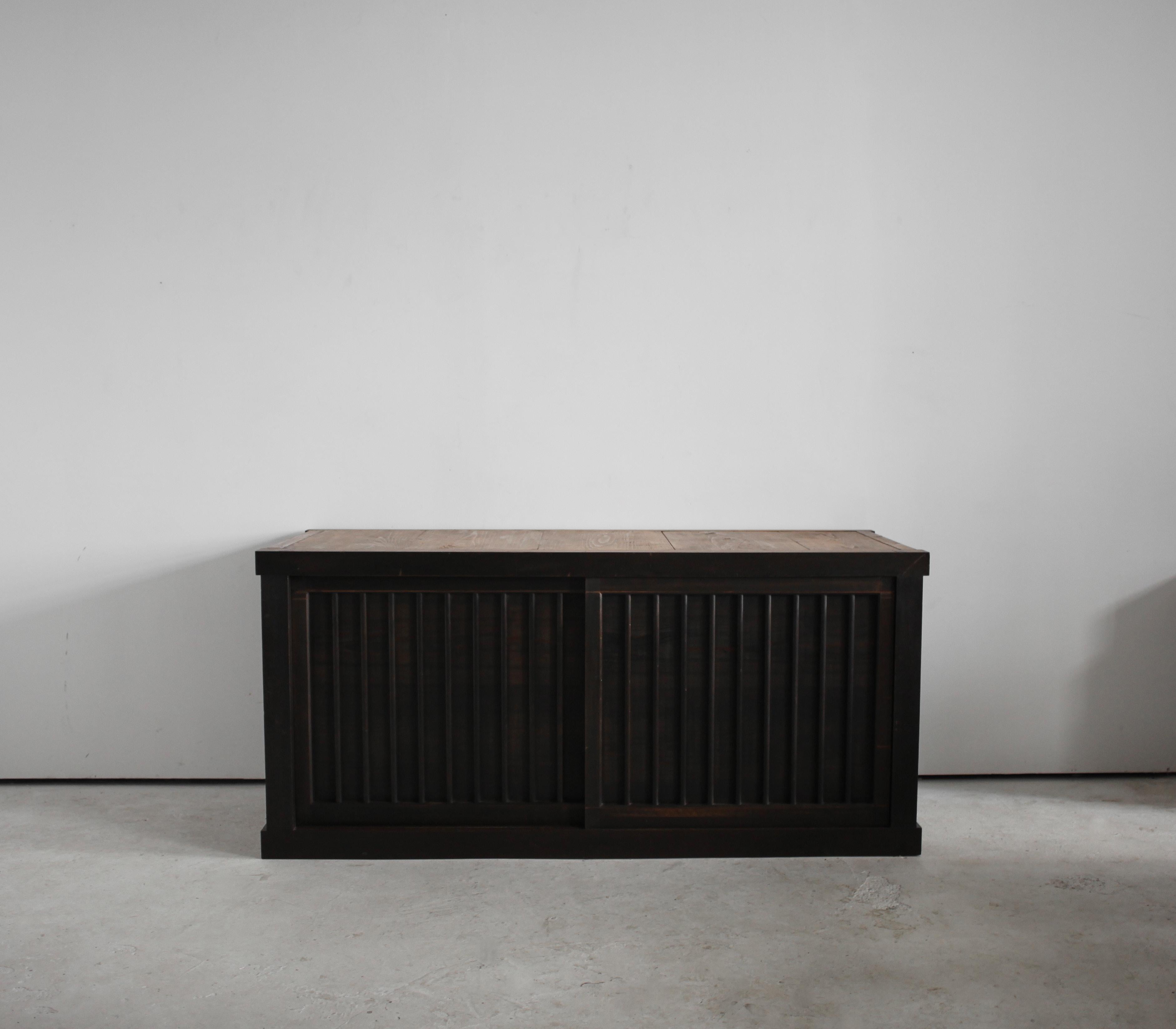 An XL beautifully patinated late 19th C. Japanese tansu/sideboard.

Constructed in cedar with two impressive slatted sliding doors revealing a single interior shelf.
