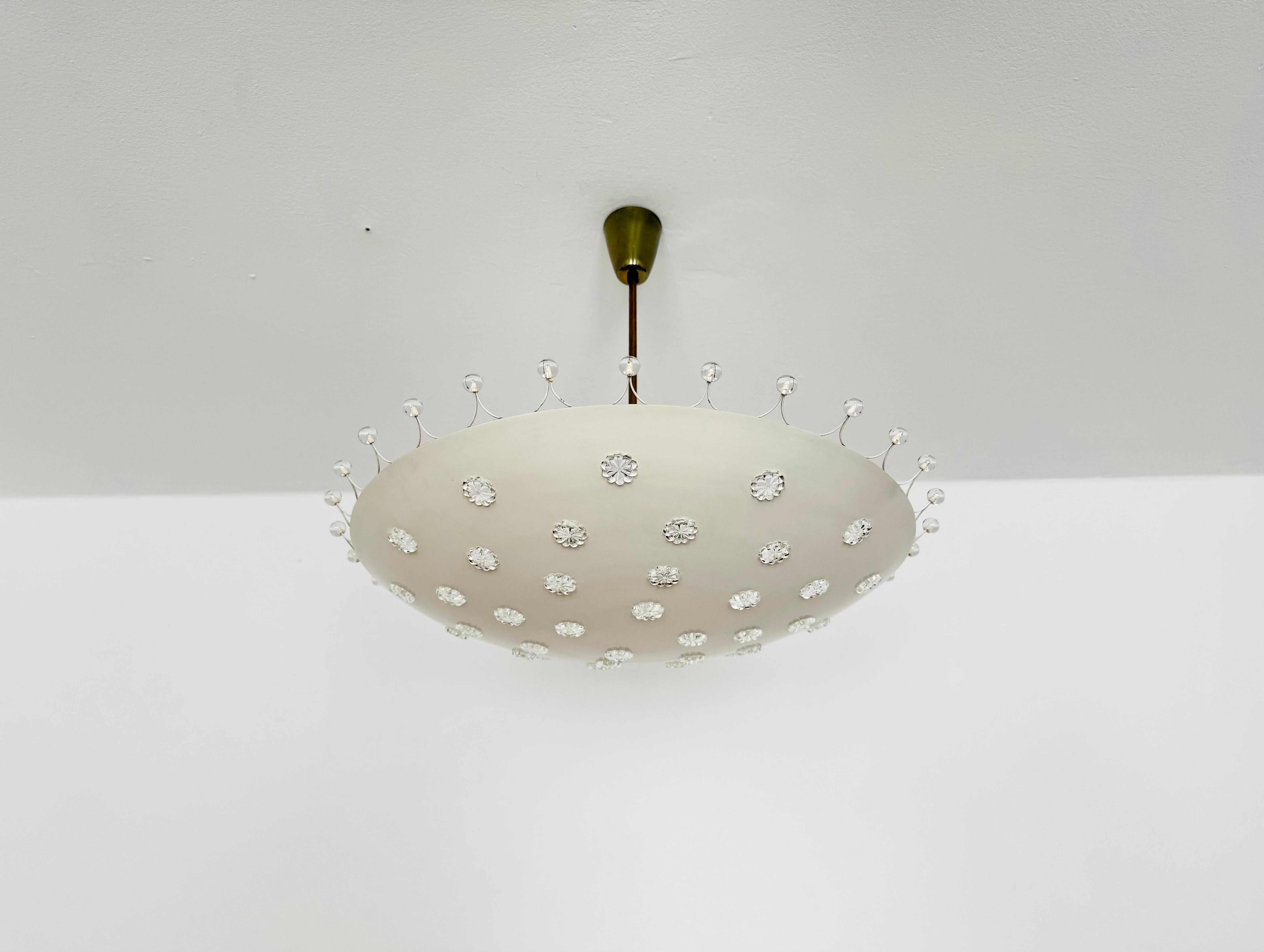 Meravigliosa lampada da soffitto molto grande degli anni '50.
La lampada, con i suoi fiori in vetro cristallo, ha un aspetto molto lussuoso e brilla meravigliosamente.
Il design e i materiali utilizzati creano una meravigliosa luce scintillante.
Una