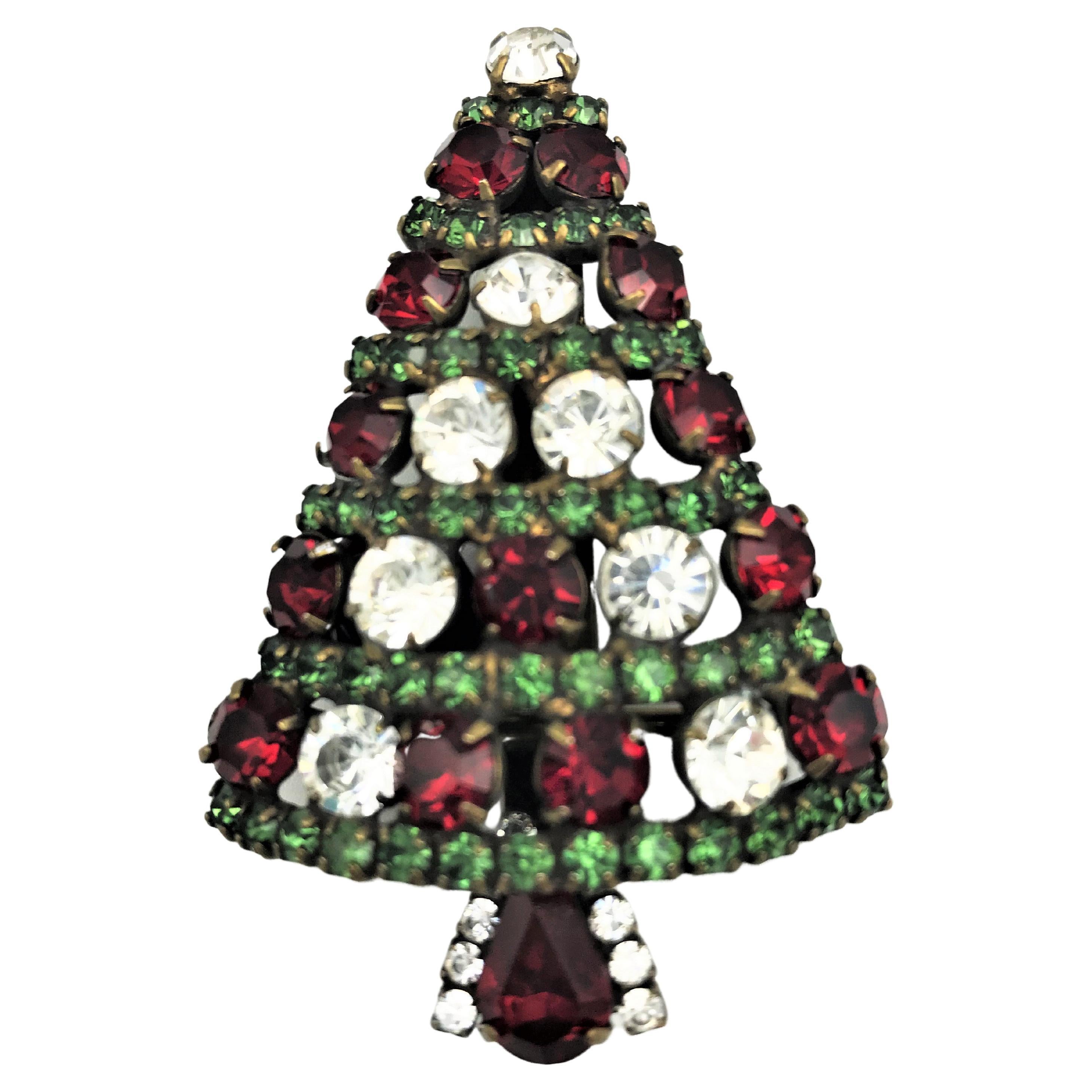 Christmas is coming soon!       Who wouldn't want to adorn themselves with a Christmas tree brooch.
This sparkling treasure is designed and manufactured in California by Dorothy Bauer. She expresses her love of color in a witty and humorous