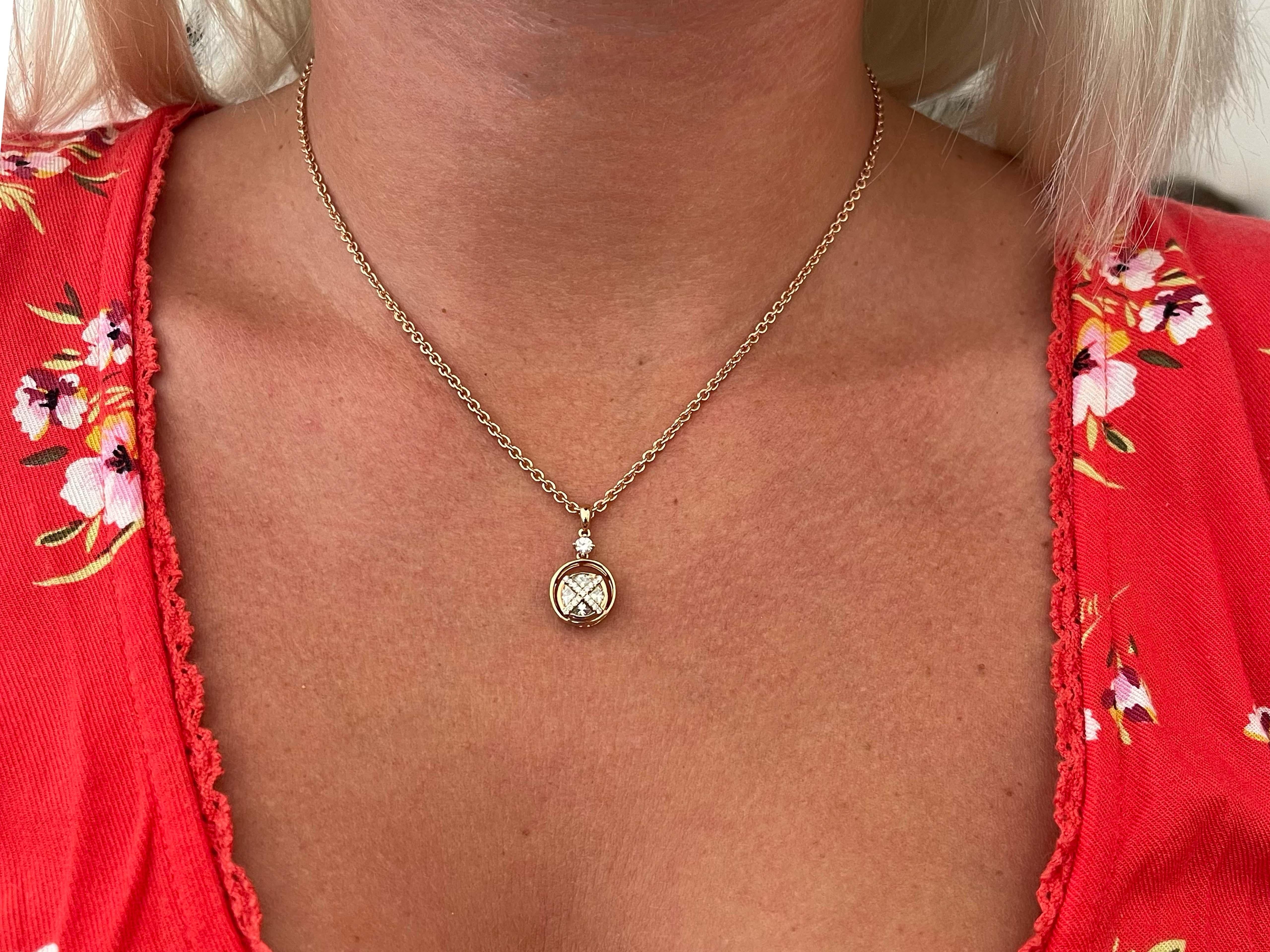 The center pie-cut diamond is G-H in color and VS in clarity and weighs 0.60 carats. The pendant features an additional 18 round brilliant diamonds, G in color and VS in clarity, weighing 0.18 carats. Altogether the diamond weight is 0.78 carats.