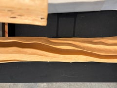 Sculture in bosso, lucidissime e intagliate per la contemplazione, fiume fluente