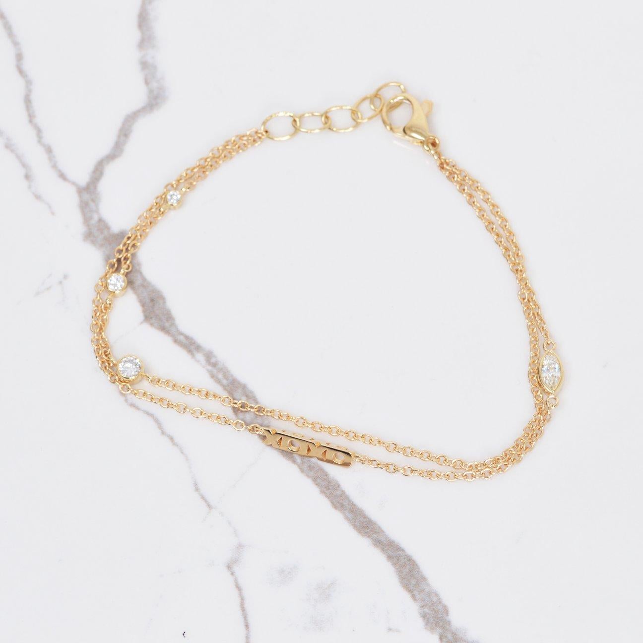 Can't feel nothing but love when wearing this stunning bracelet! This 14k yellow gold double chain bracelet has a XOXO rotating charm with beautiful diamond accents that total .39 carats. This bracelet measures 7-7.5 inches.